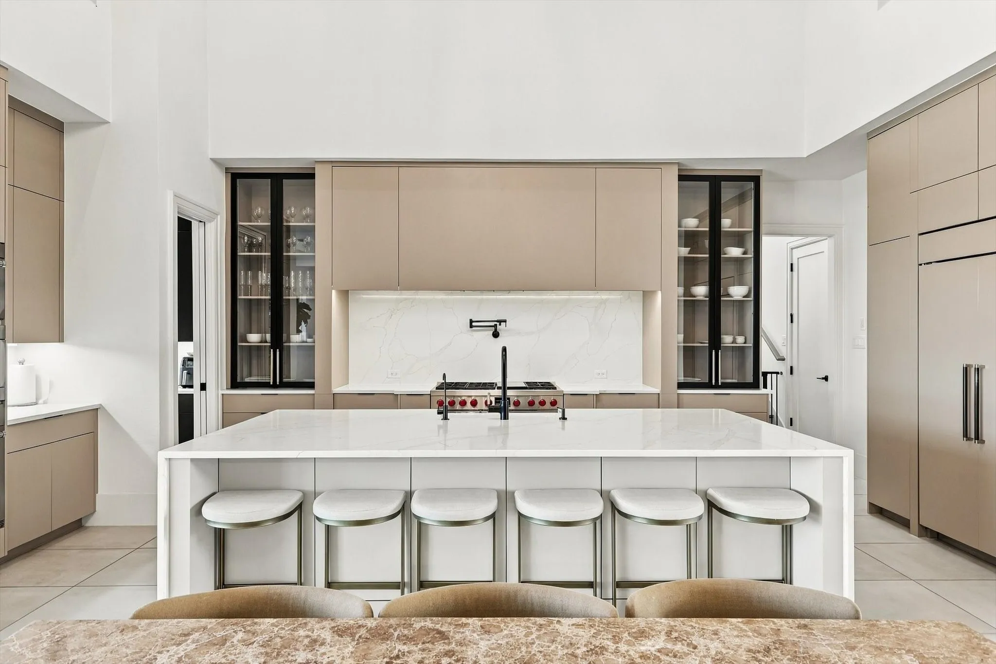 Kitchen featuring a large center island with seating, integrated appliances, and a built-in range
