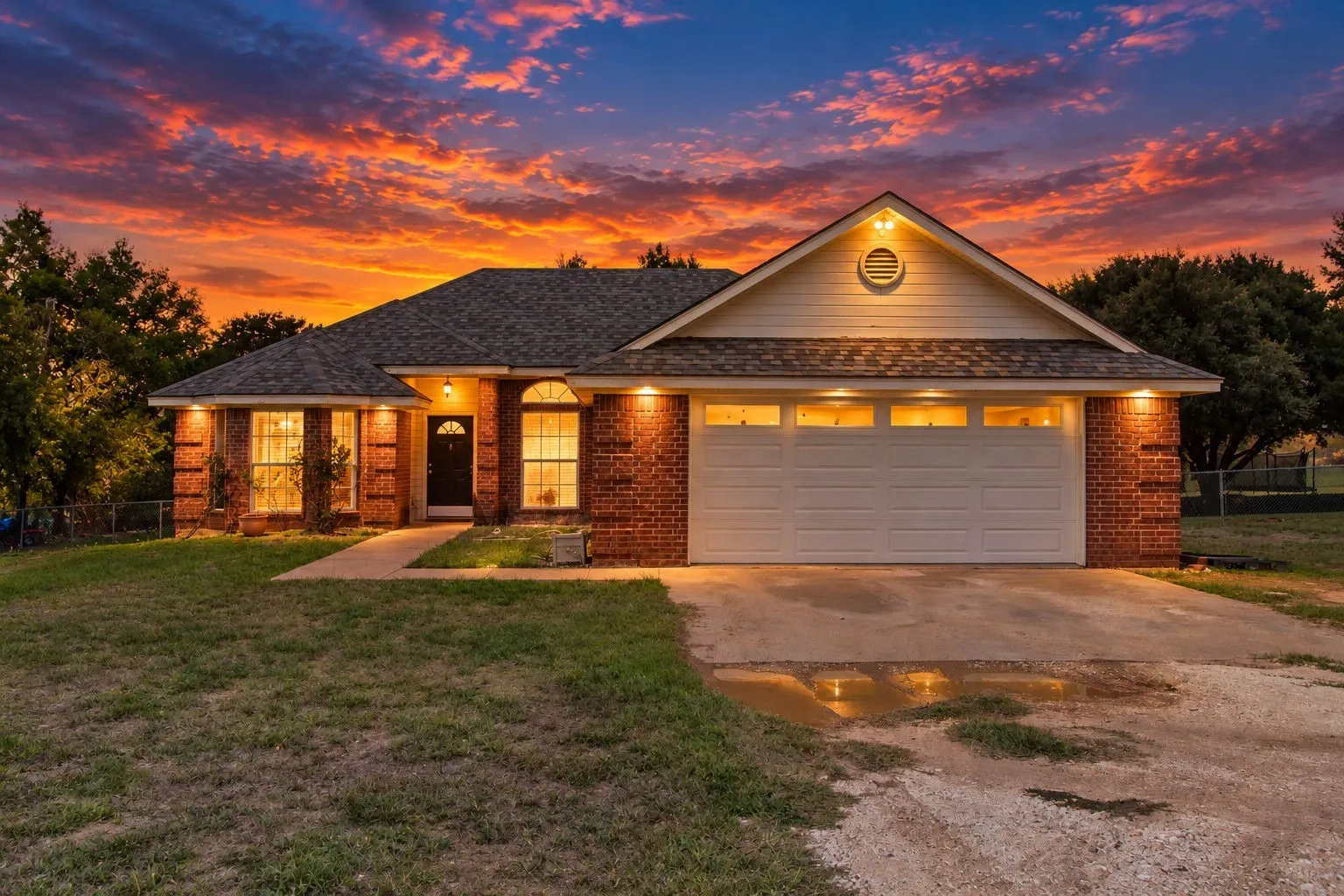 Brick exterior with white siding accents and a pitched roof