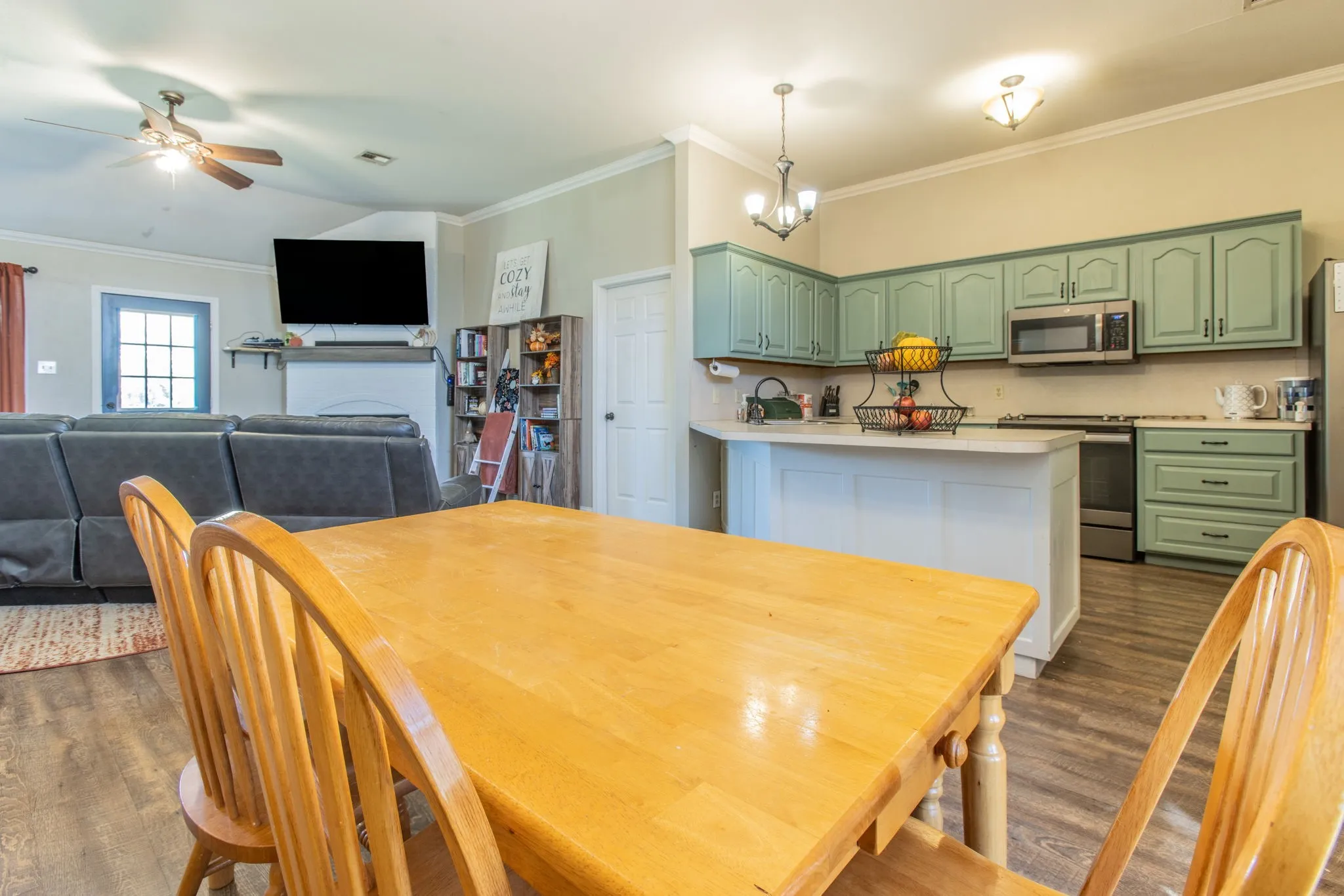 Spacious kitchen featuring painted cabinetry, stainless steel appliances, and a central island