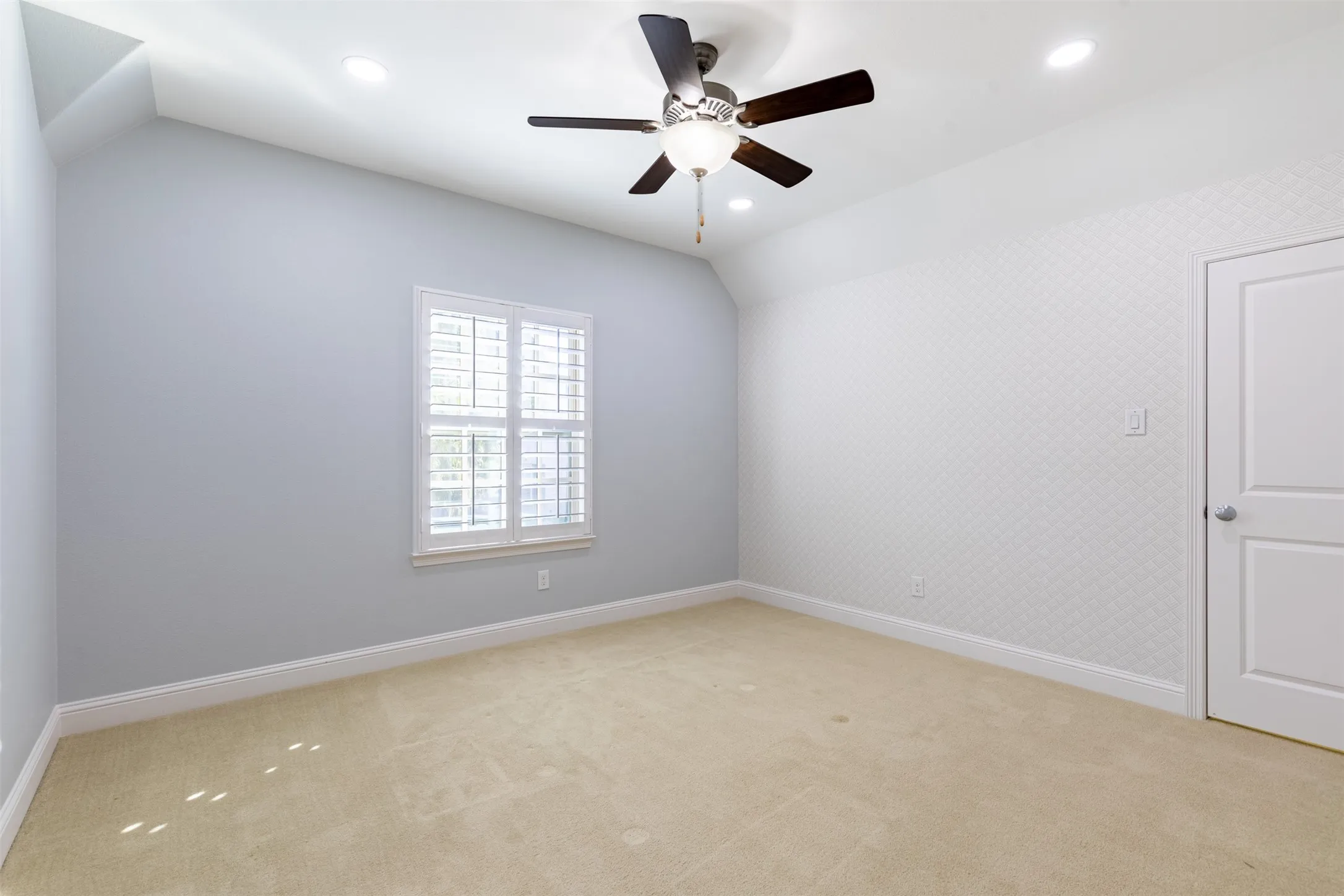 Secondary upstairs bedroom with ceiling fan.