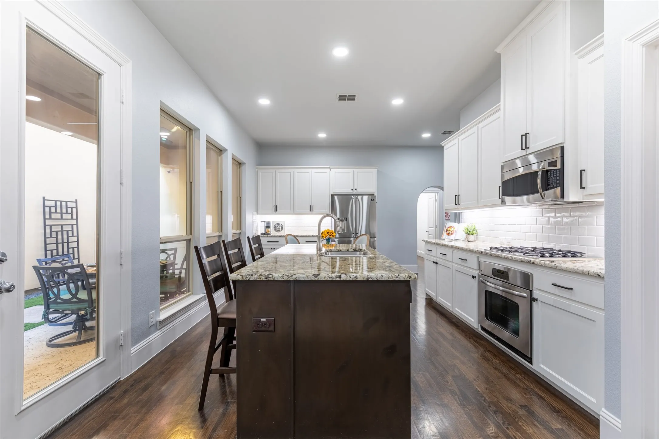 Spacious kitchen with pristine white cabinetry.