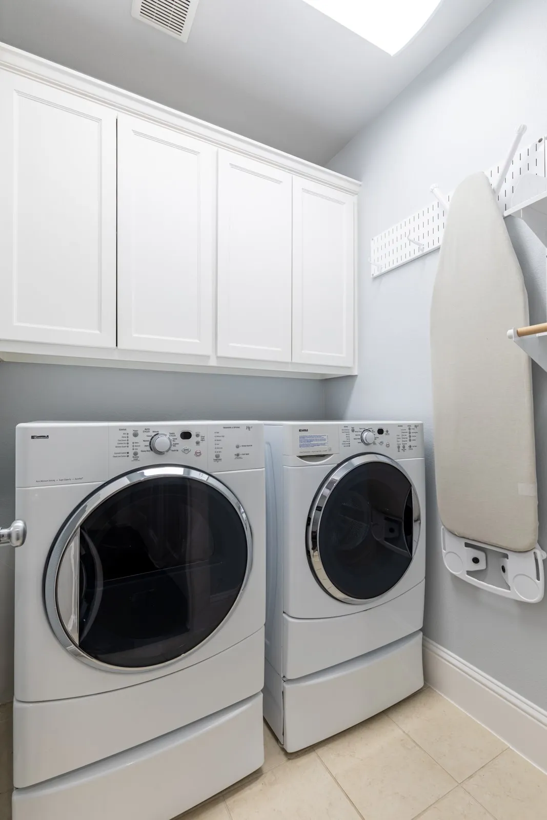 Laundry room with built-in cabinetry.
