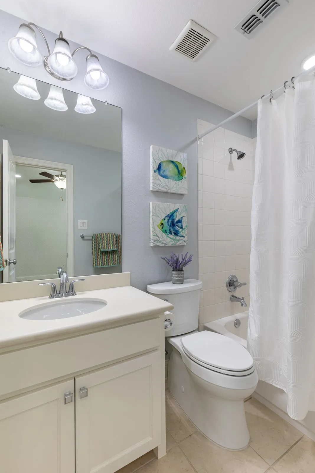 En-suite bath with tub shower combo.