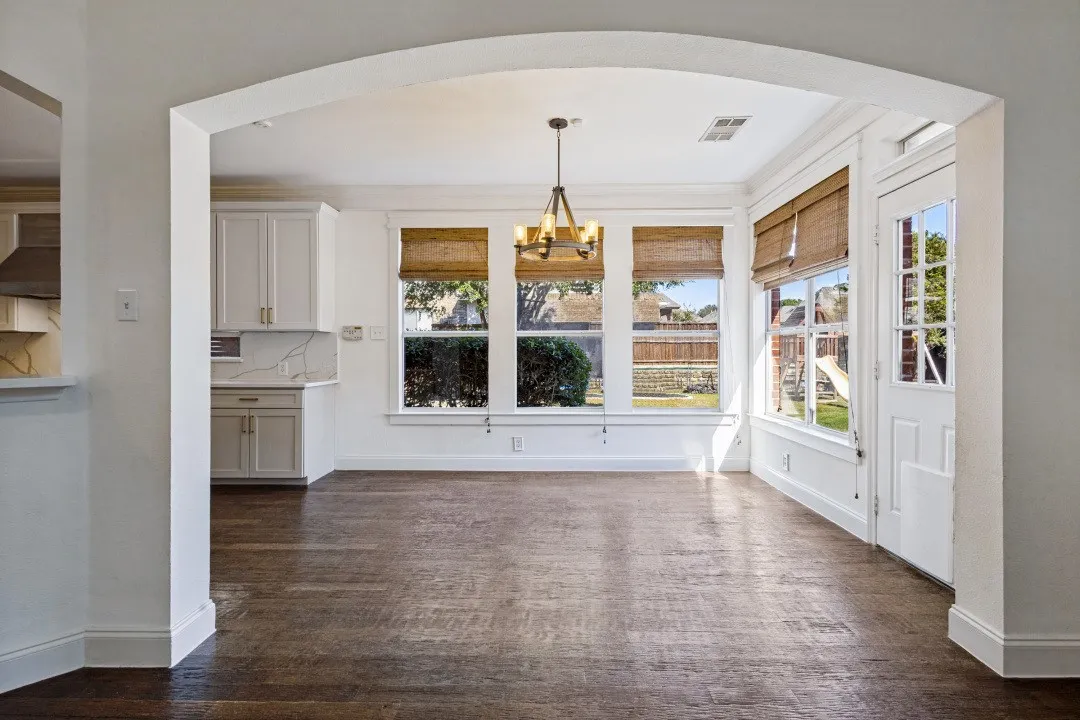 DINING AREA SITS OF THE KITCHEN OVERLOOKING THE SIDE YARD AND BACK PATIO AREA