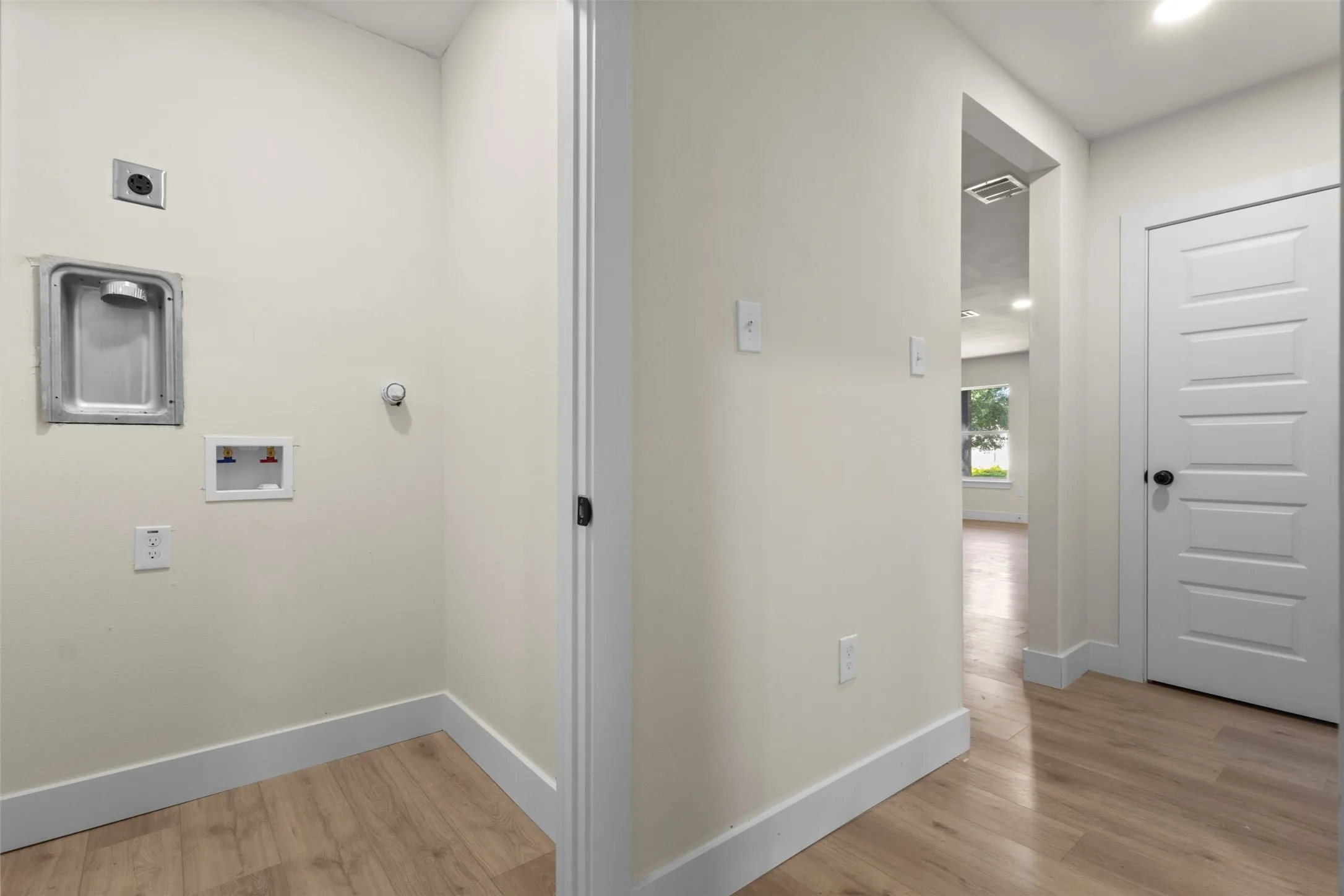 Dedicated utility area with wood-finish flooring