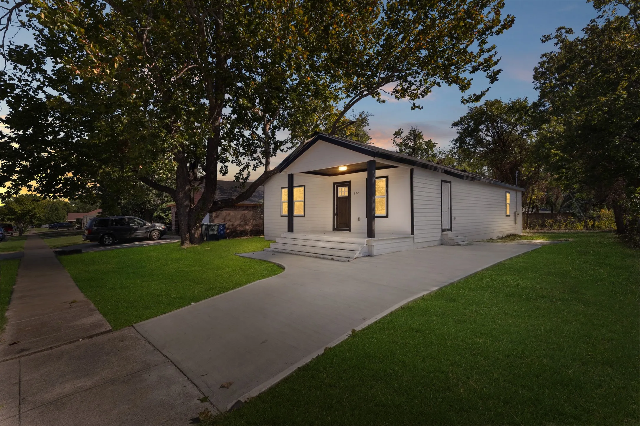 Contemporary exterior with white siding and dark trim