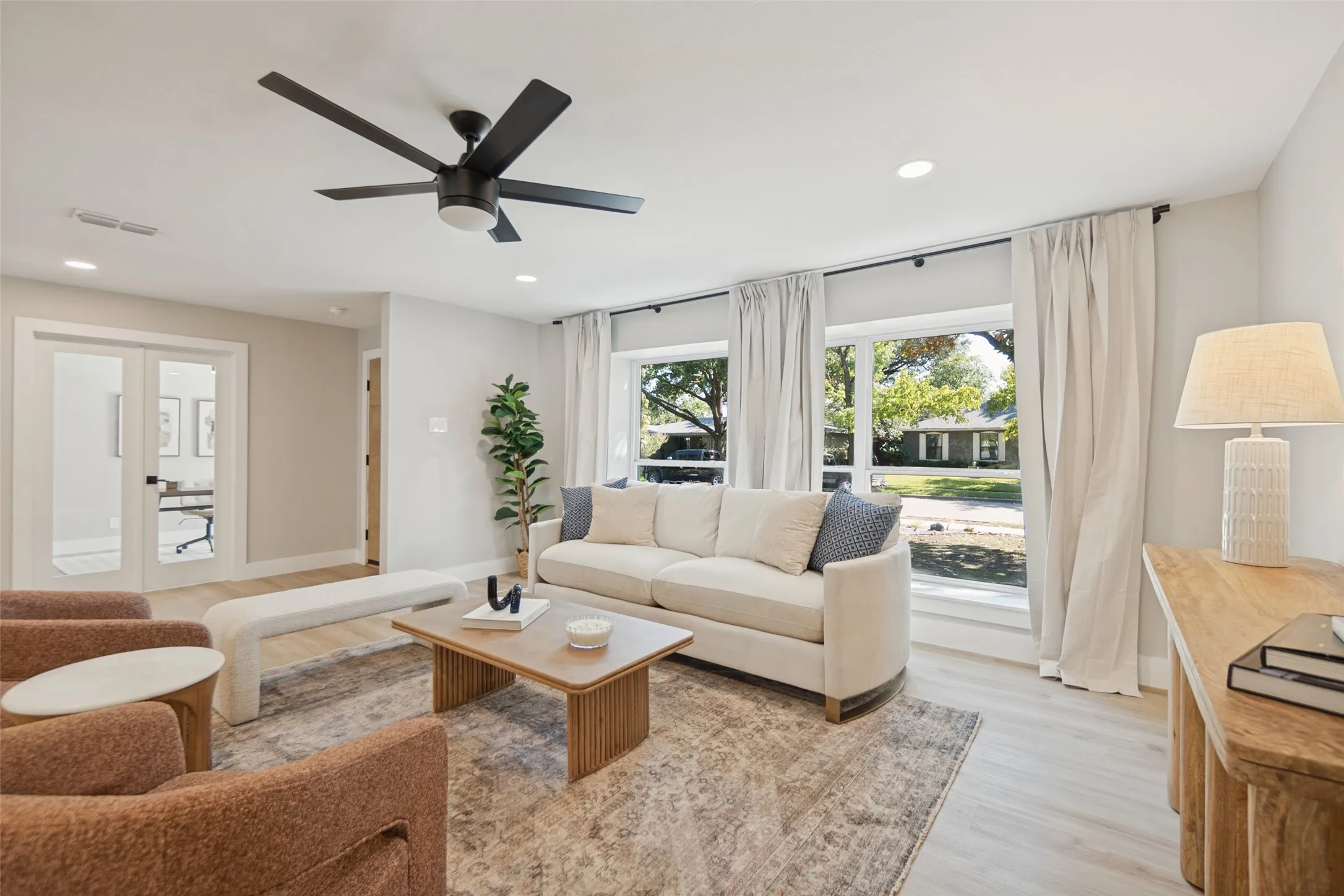 Recessed lighting, wood-finish flooring, and a modern ceiling fan