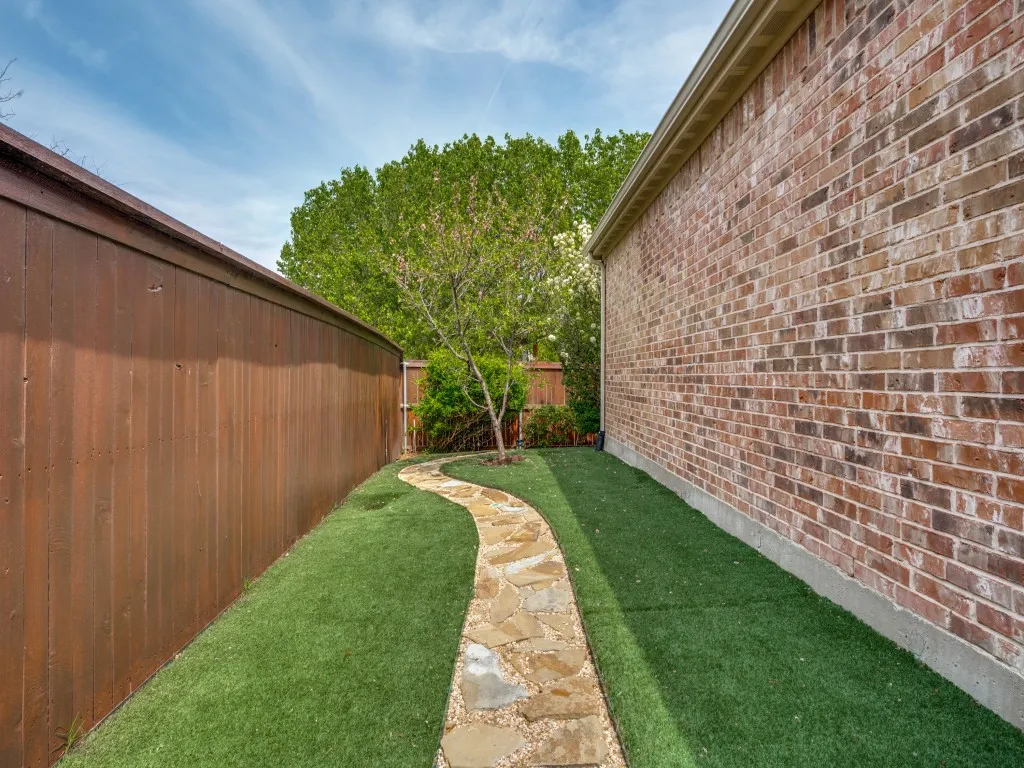 AstroTurf, perennial landscaping, and a peach tree add beauty without the upkeep