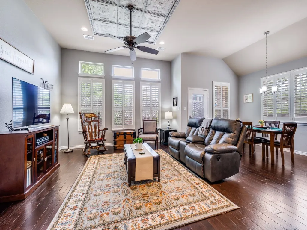 Gorgeous wood floors and abundant natural light create a warm, inviting living space.