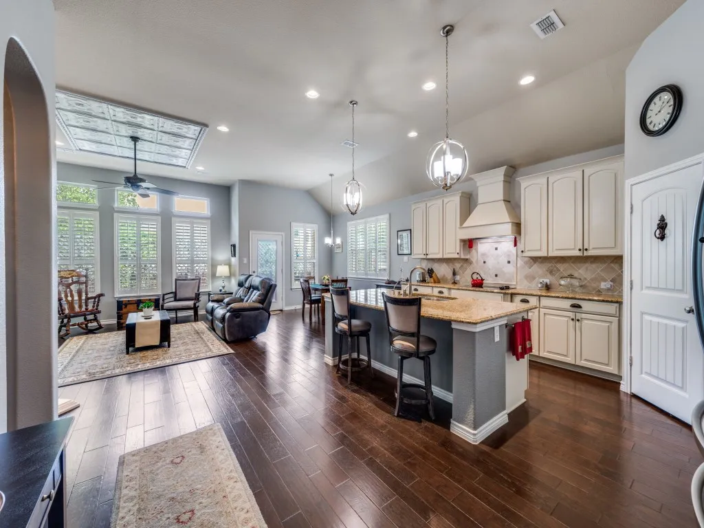 Elegant plantation shutters and upgraded lighting add timeless style throughout.