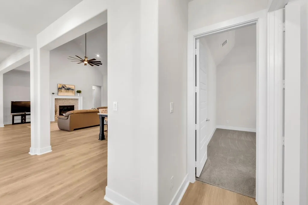 Wood-finish flooring throughout, vaulted ceiling, and recessed lighting