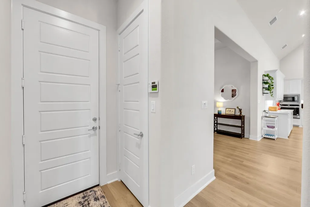 White panel doors, light wood-finish flooring, and recessed ceiling lighting