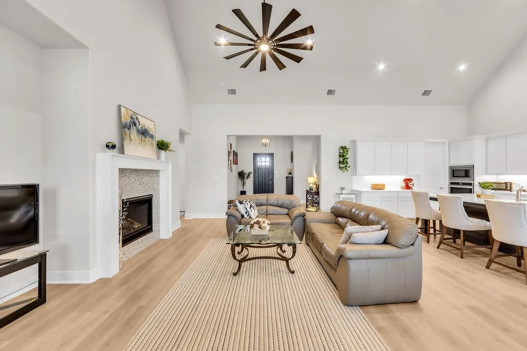 Vaulted ceilings, a tile fireplace, and wood-finish flooring