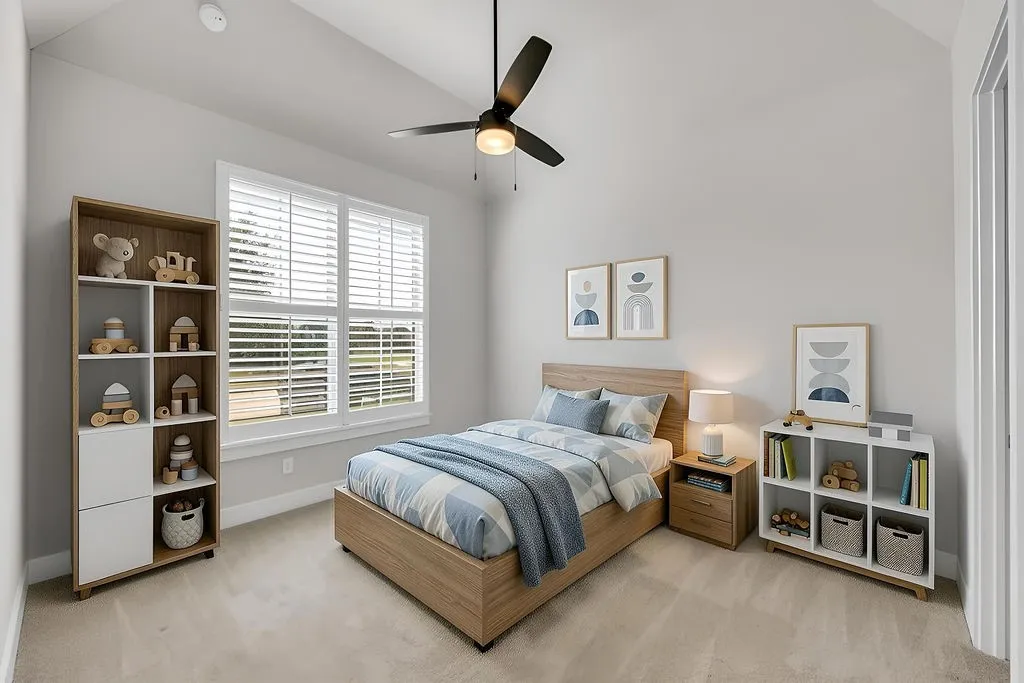Vaulted ceiling, ceiling fan with light fixture, window with blinds, light-toned carpeting, and neutral wall paint