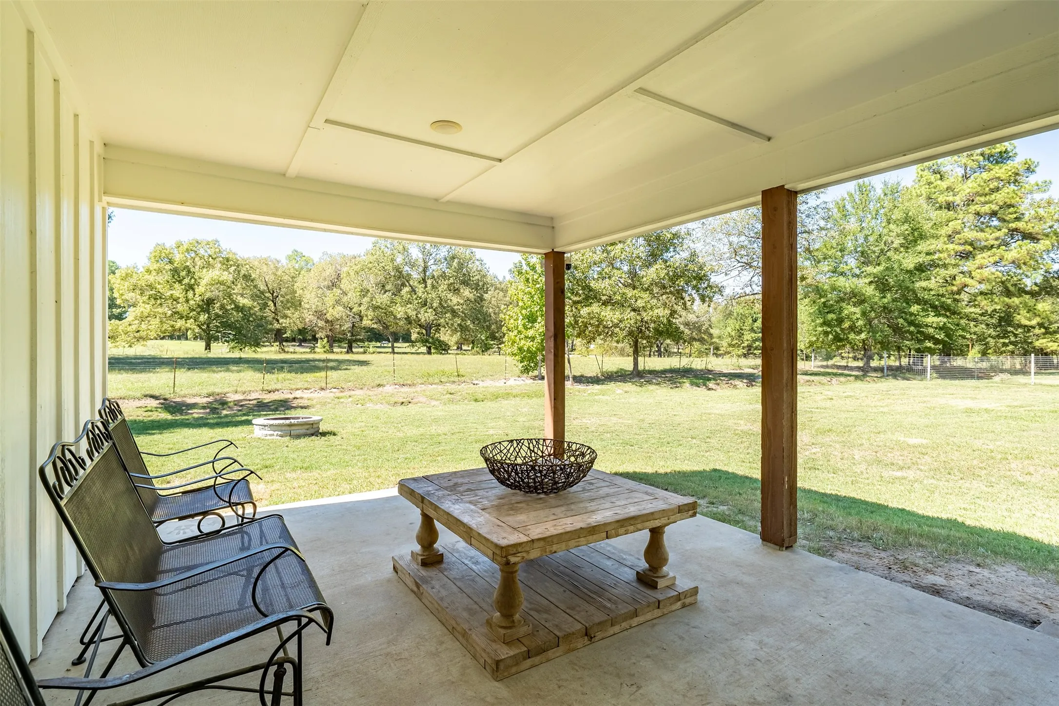 Covered concrete patio with wood-finish support columns