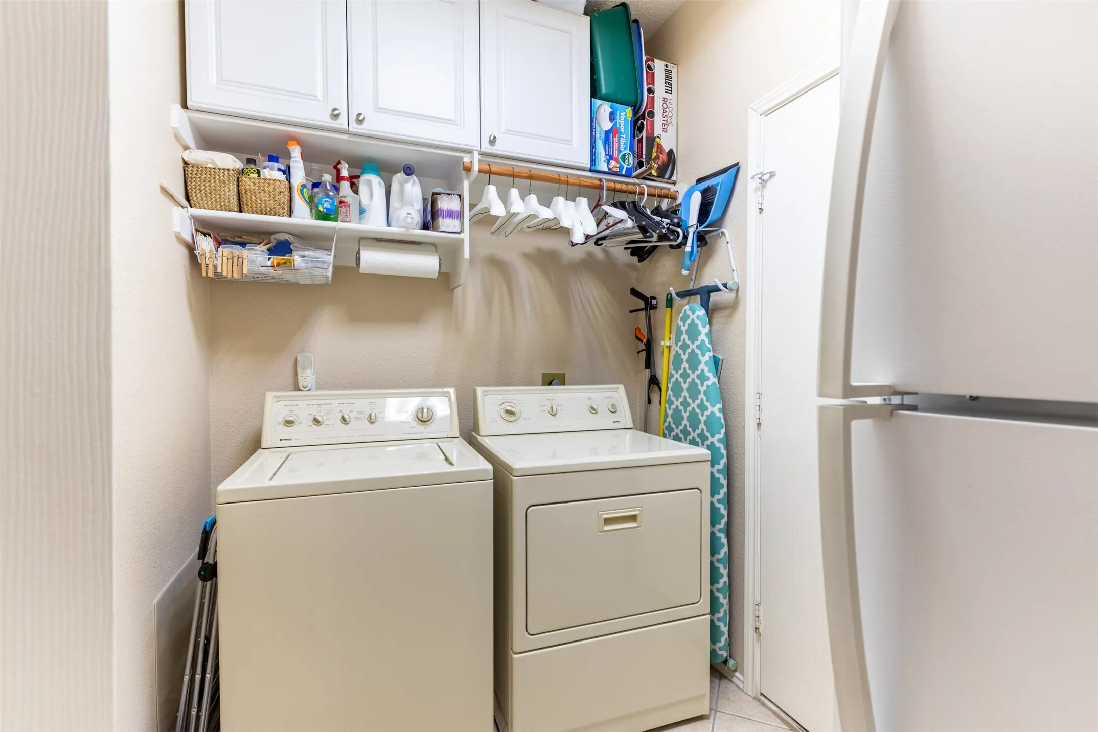 Laundry room with cabinetry.
