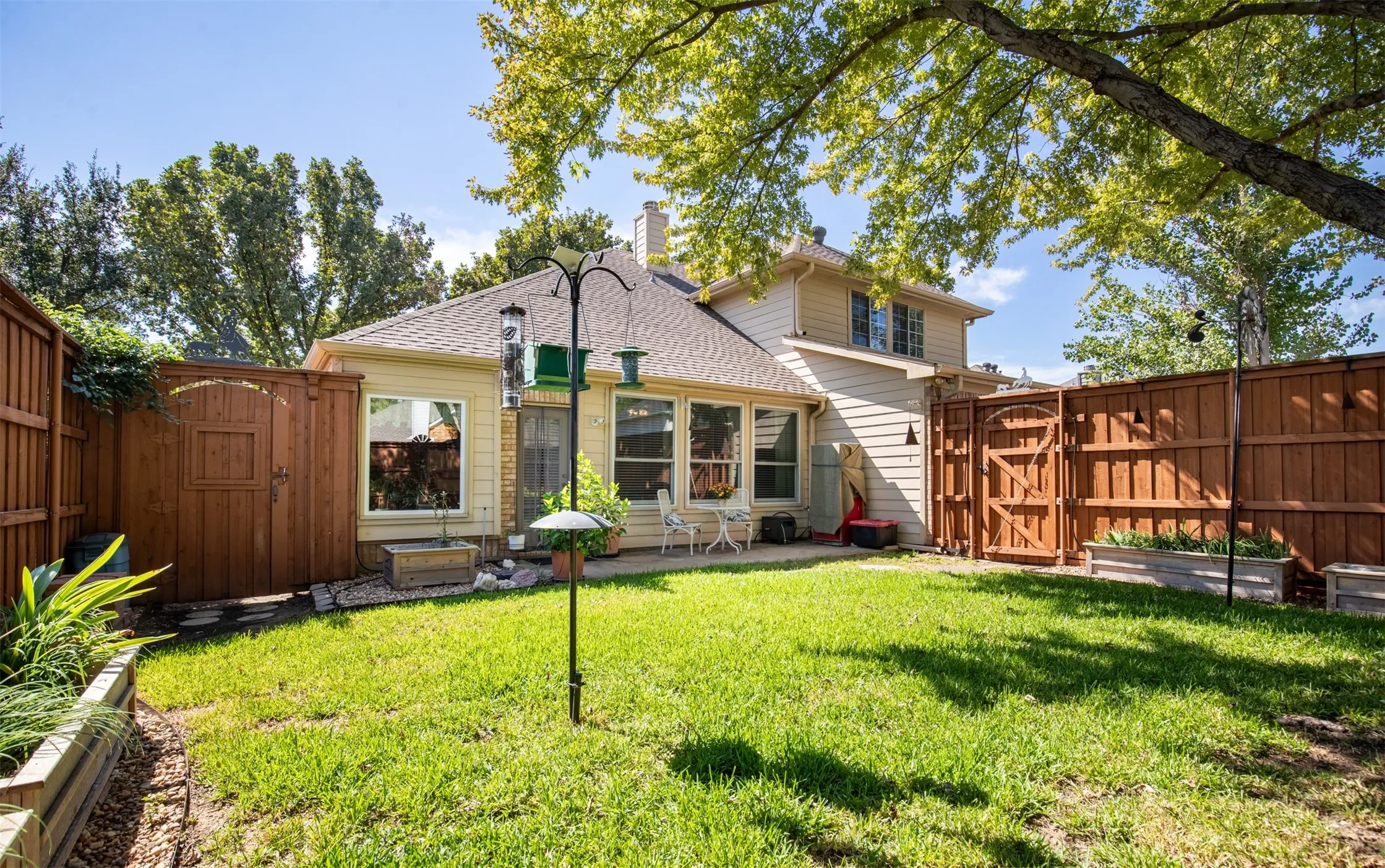 Beautiful backyard with landscaping and grassy yard.