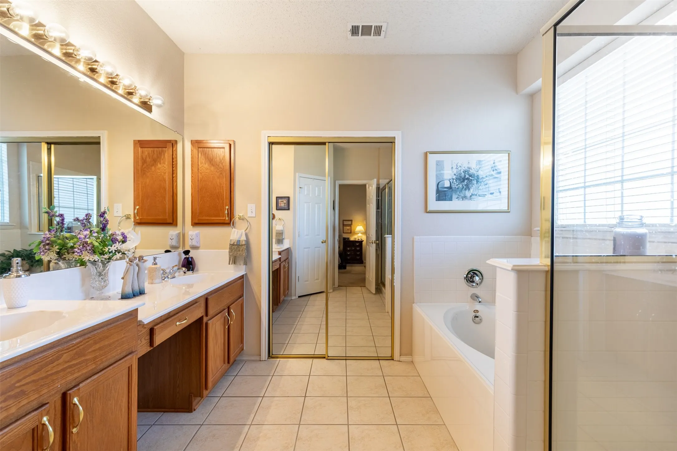 En-suite bath with dual sinks.