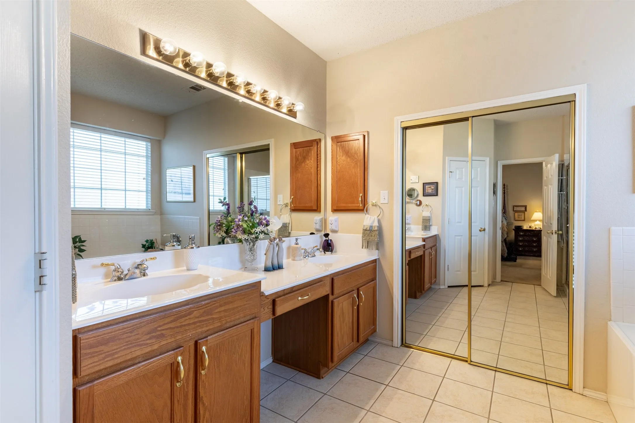 En-suite bath with vanity seating area.