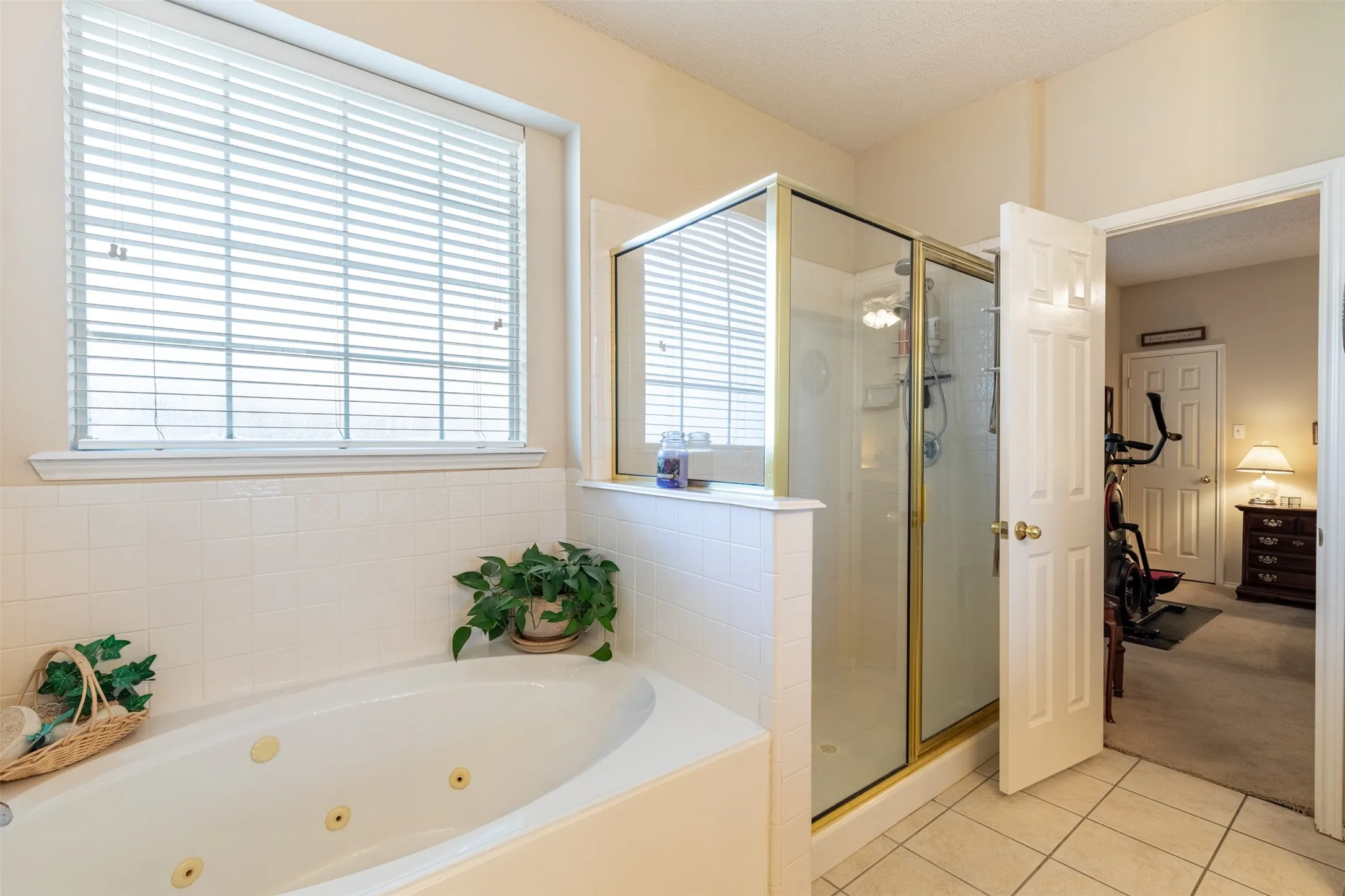 En-suite bath with jetted tub and separate shower.