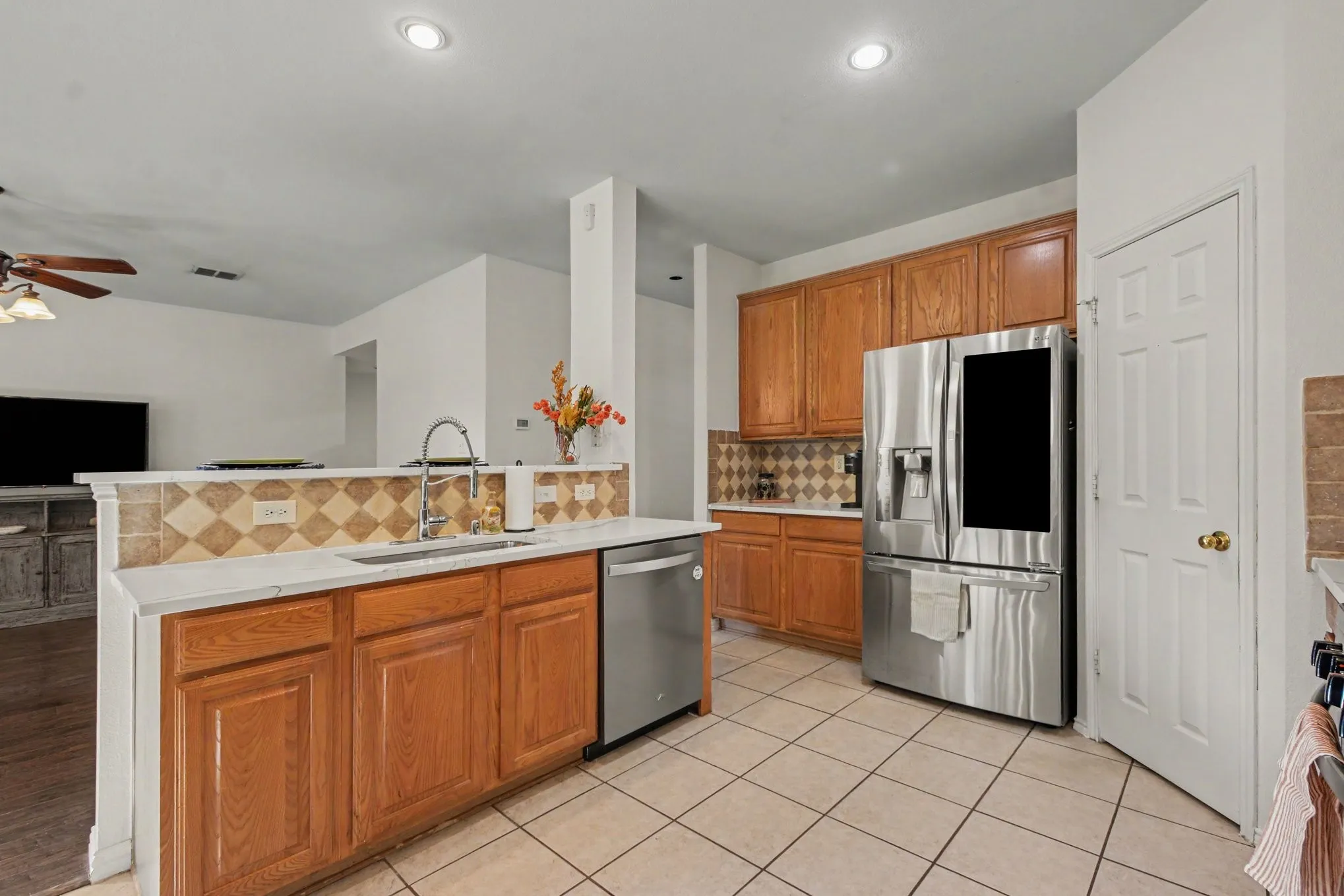 Stainless steel appliances, & new quartz counter tops wood cabinetry.
