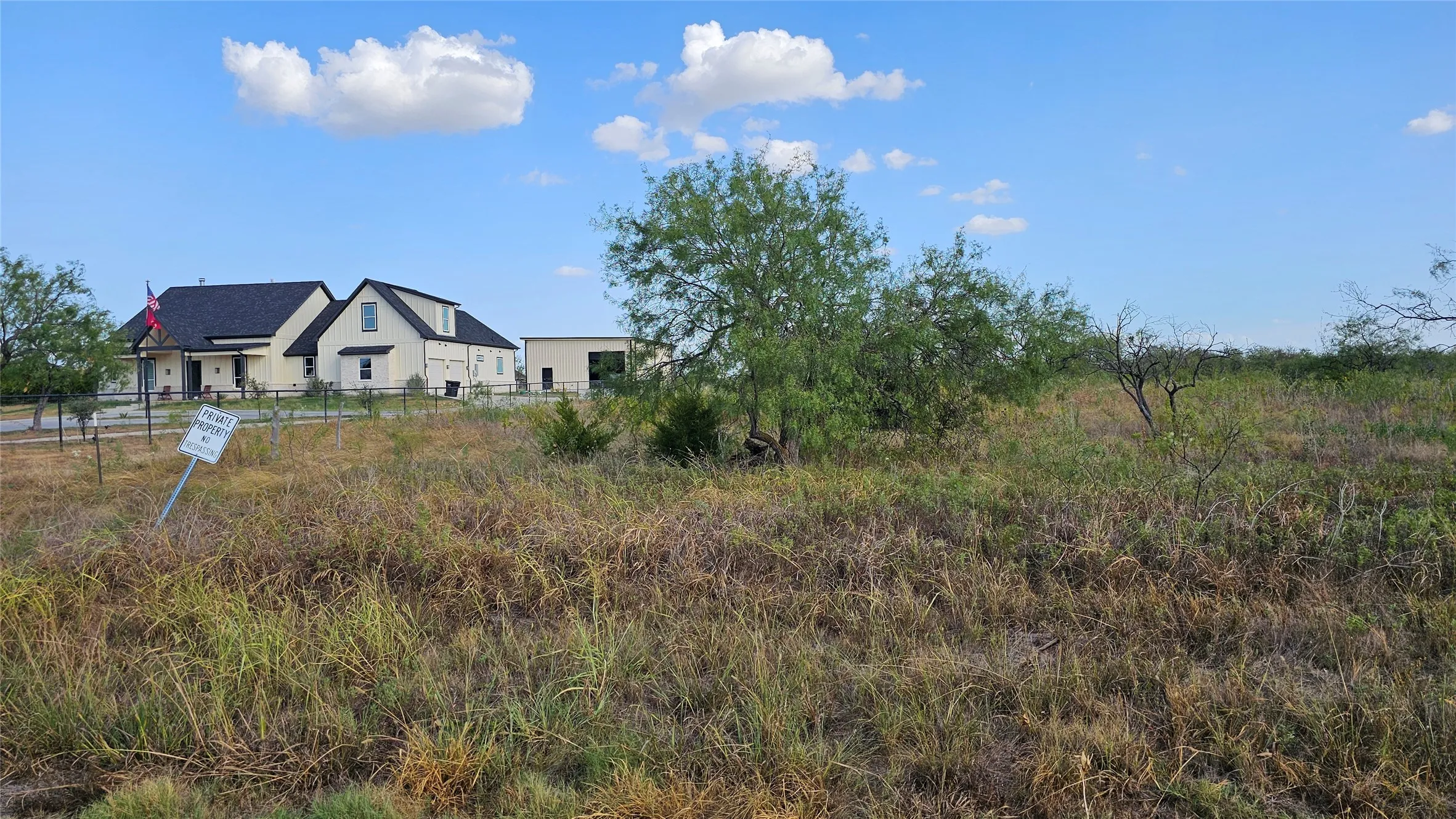 Neighboring custom-built home to the left of the property looking east.