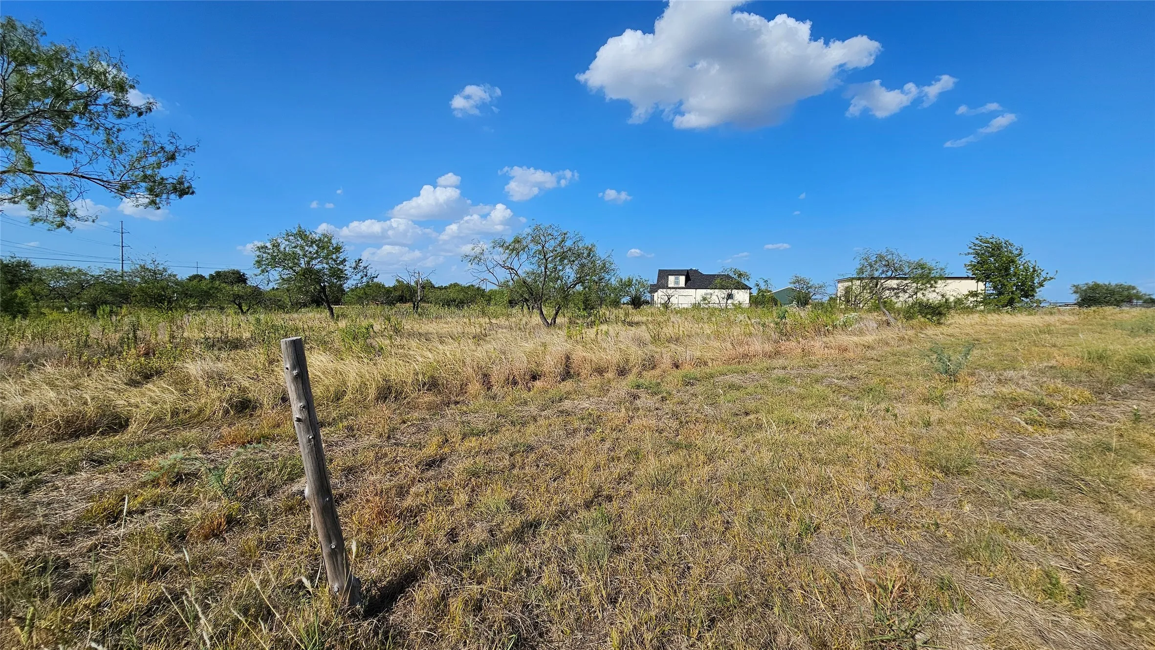 Expansive open land looking toward north showing neighbor's property.