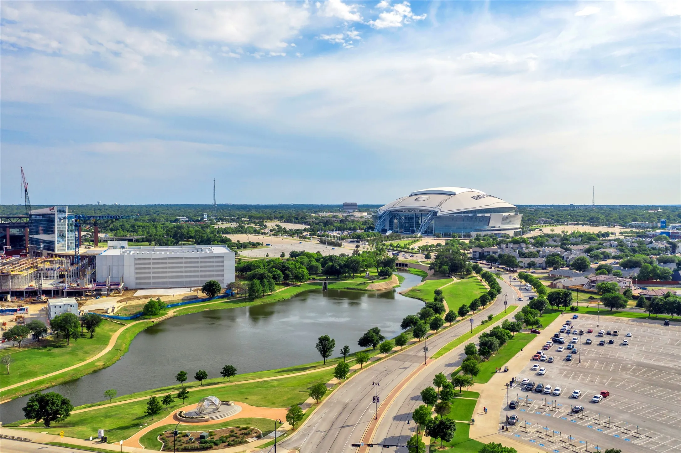 Aerial perspective showcasing premium waterfront positioning with manicured grounds, mature landscaping along the water's edge, and expansive green space