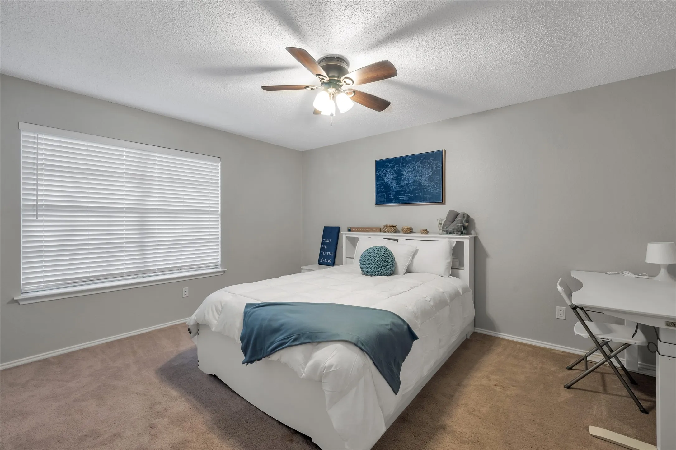 Carpeted flooring, window with blinds, ceiling fan with light fixture, light gray wall paint, white trim