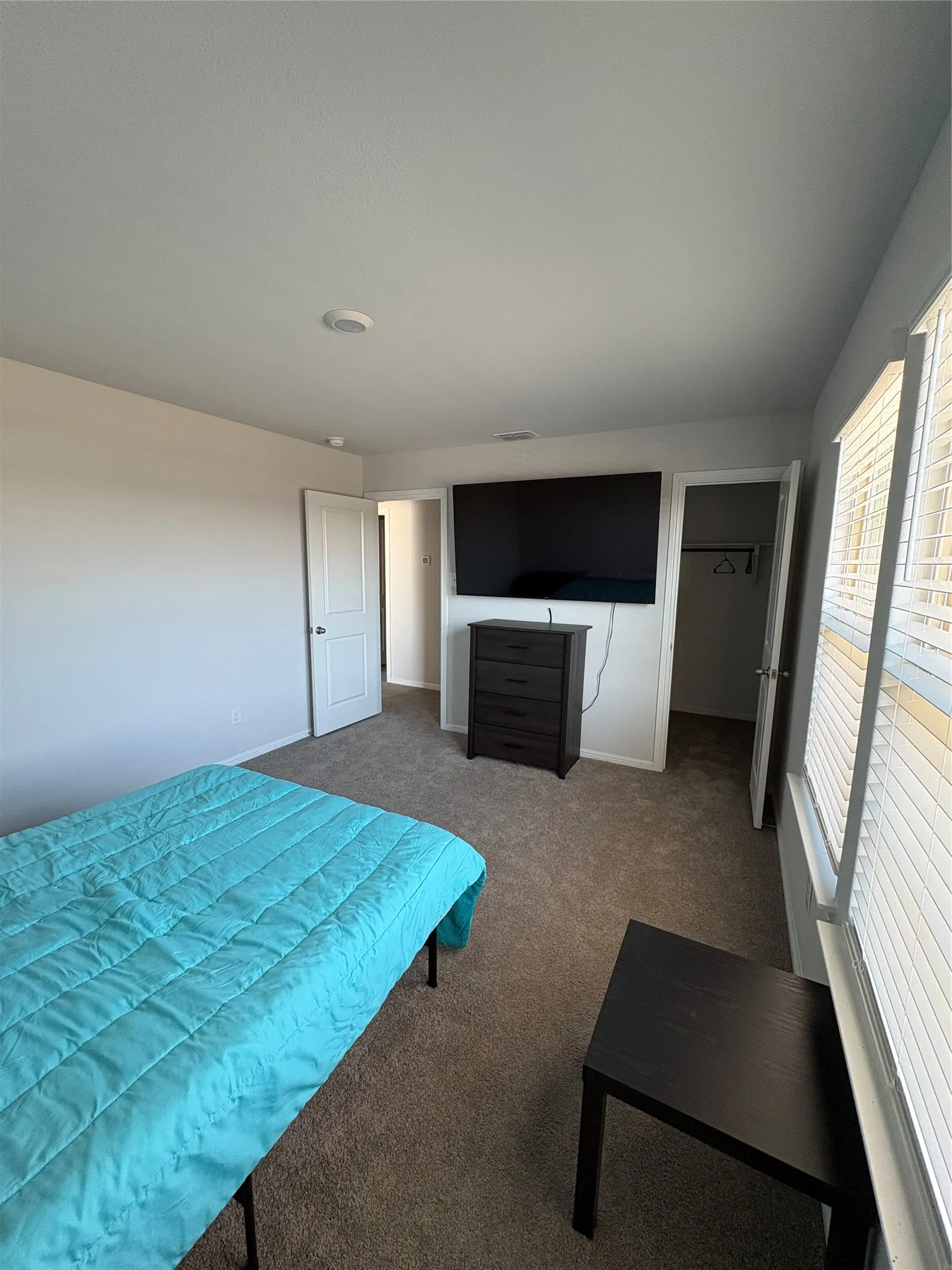Wall-to-wall carpeting and white walls