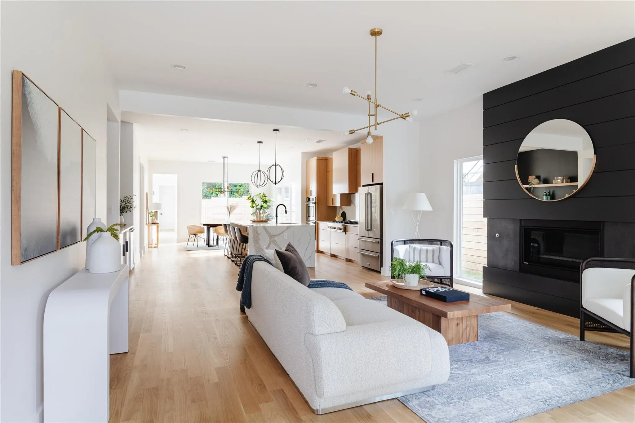 Open-concept living area featuring light wood-finish flooring