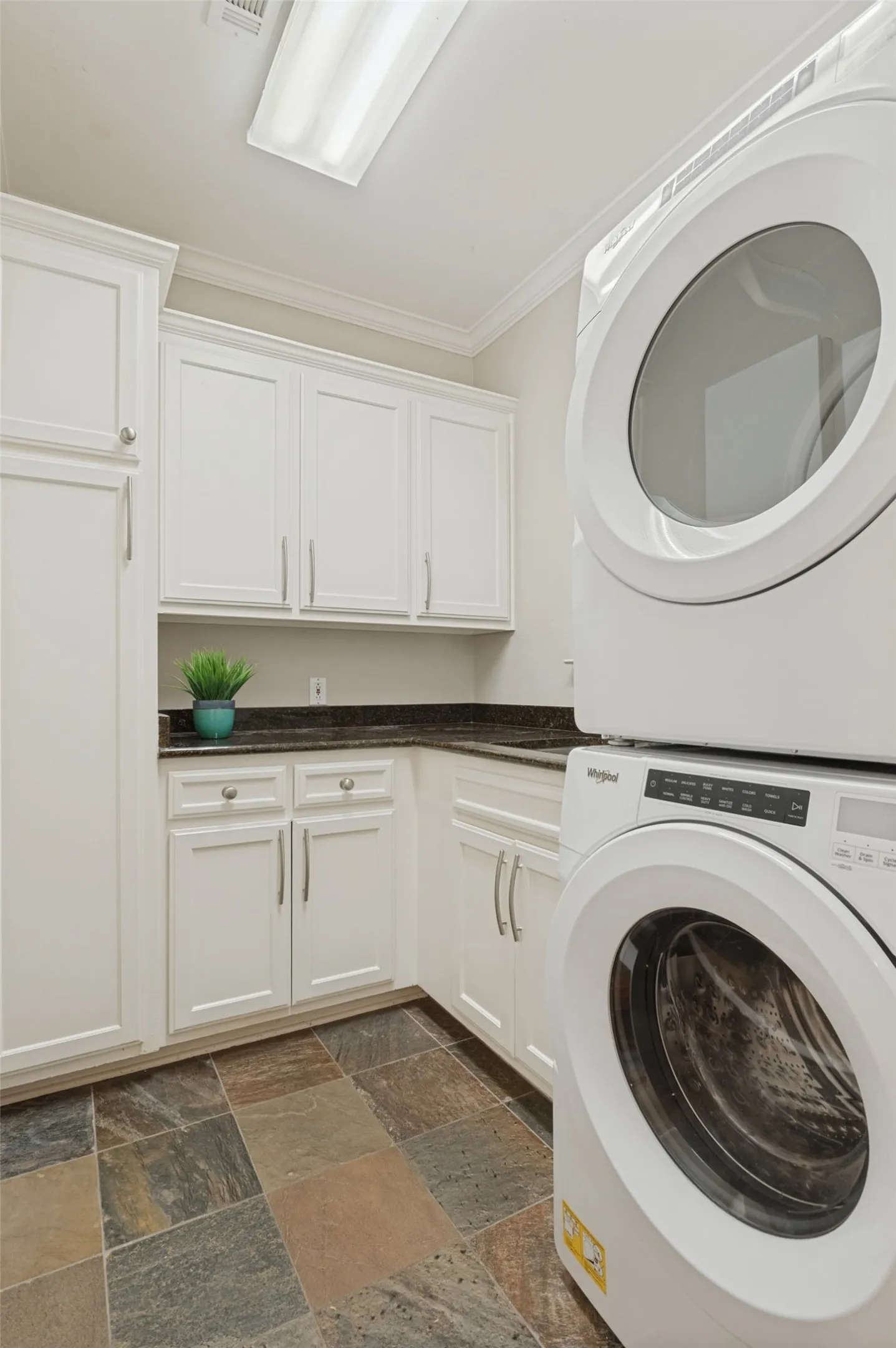 Utility room with stacked washwer/dryer