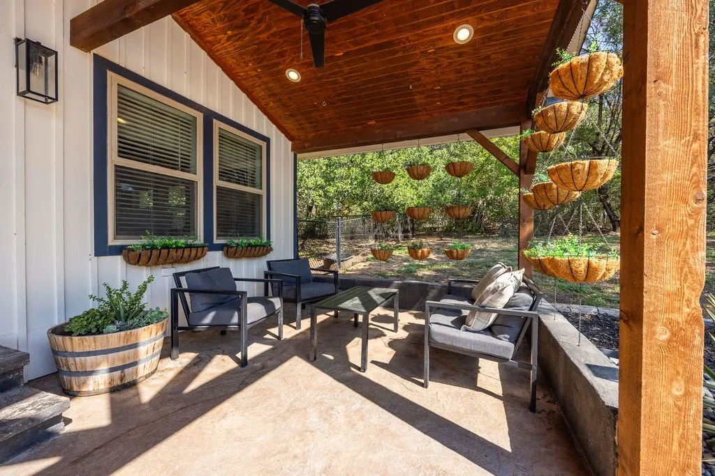 Covered outdoor patio with a stained wood ceiling and recessed lighting