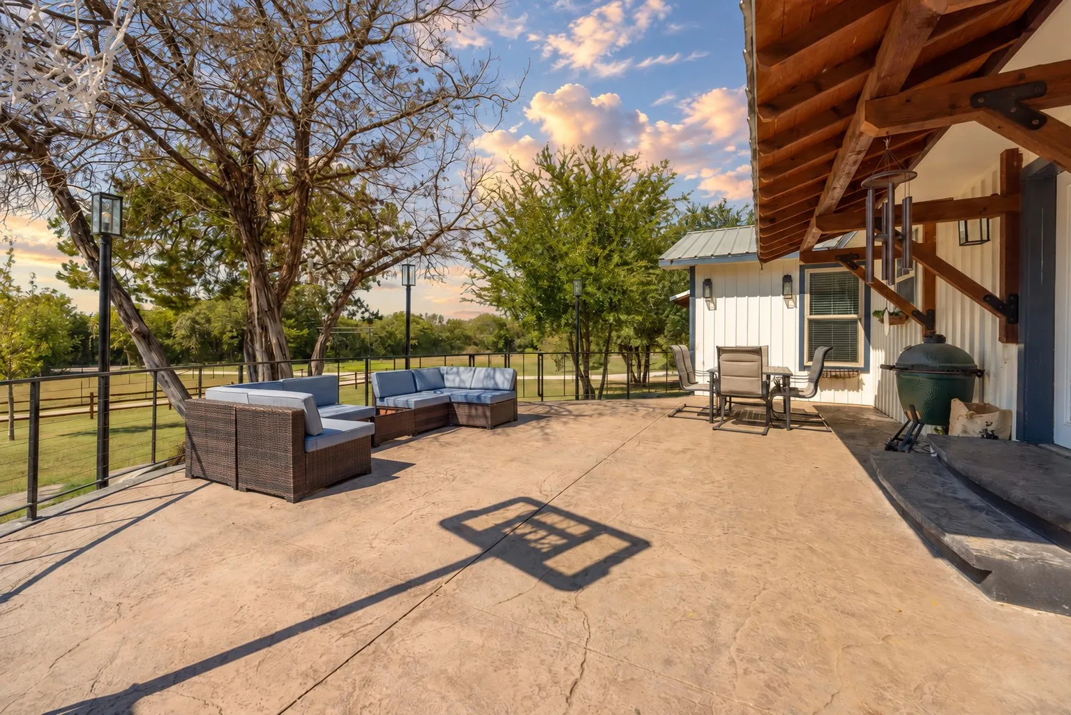 Stamped concrete patio with integrated lighting and a metal railing