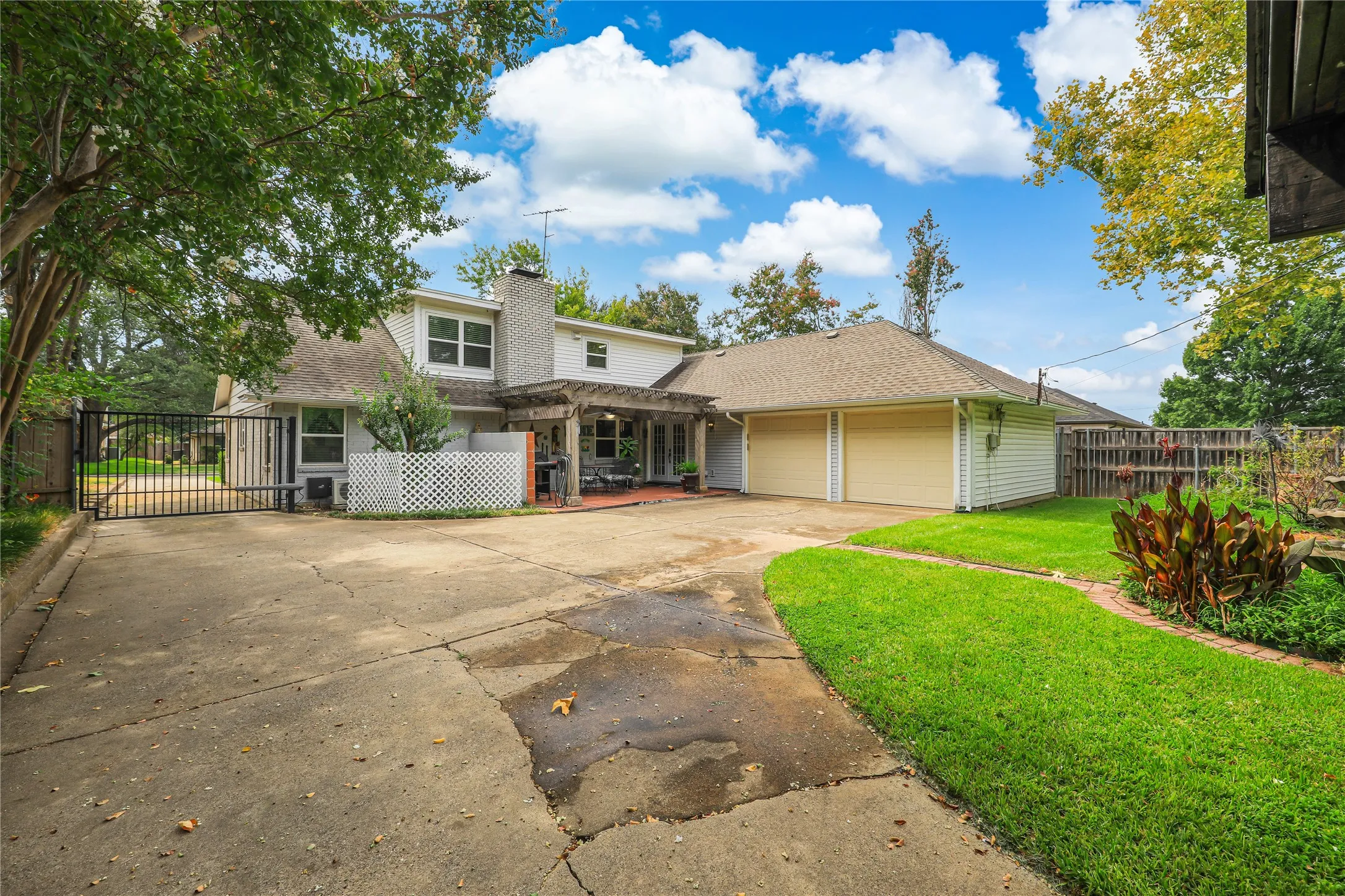 Back views of 614 Winchester wit plenty of room for extra parking.  There is a third covered carport as well as a storage in the backyard!