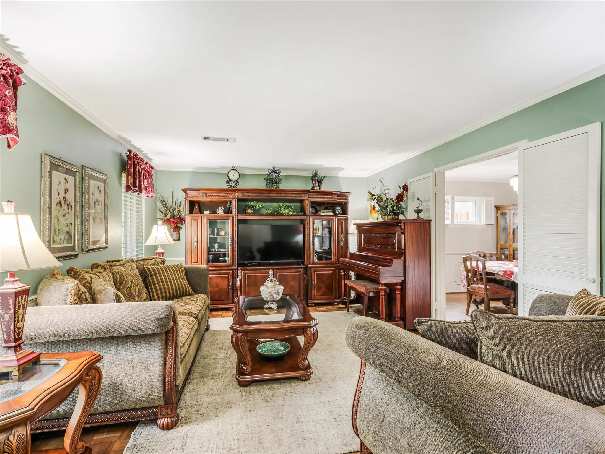 Relaxing formal  living area has plenty of wall space and ideal for enertaining opens to formal dining!