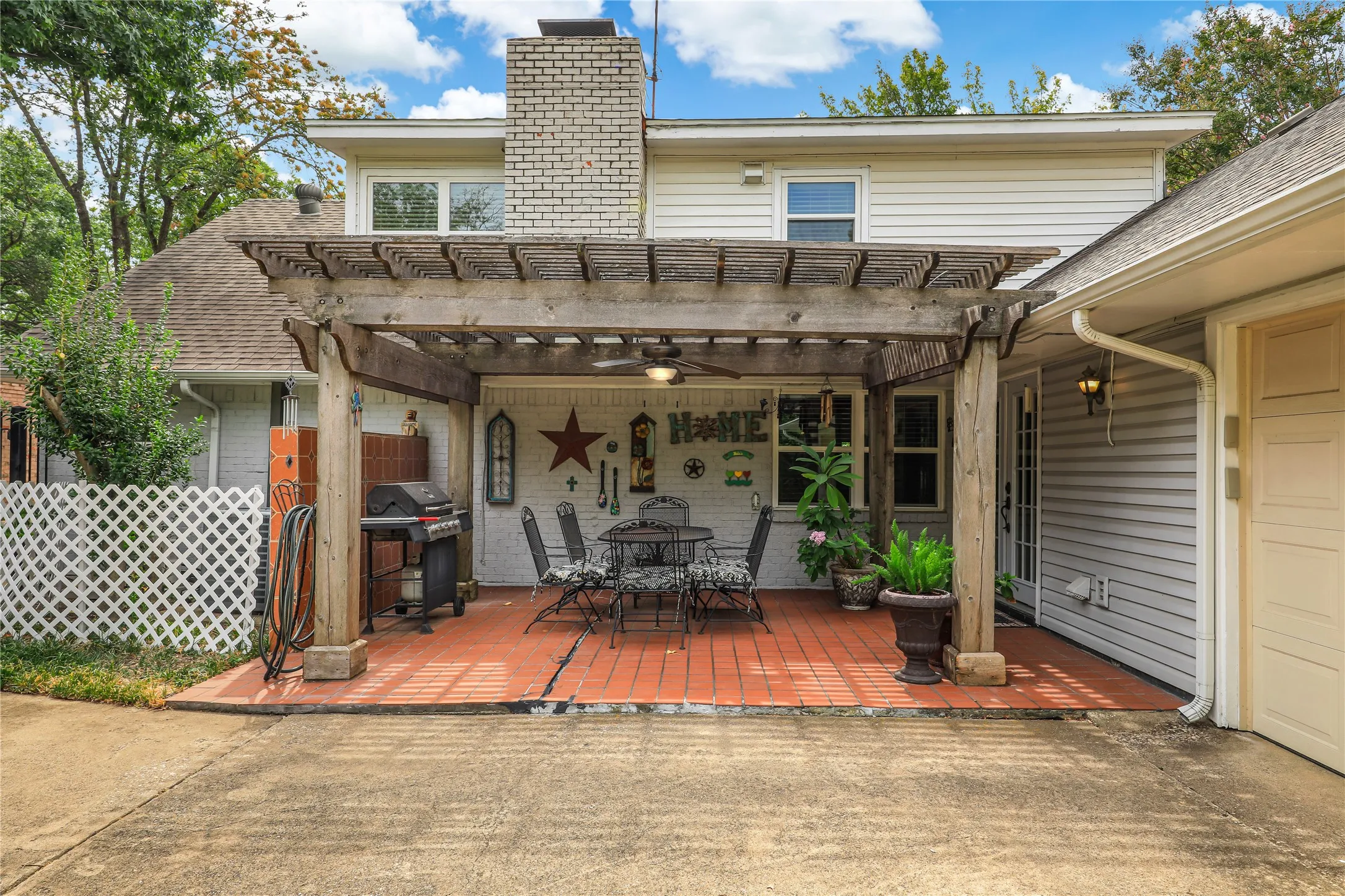 Outdoor patio with tiled flooring and ideal for grilling and easy access to kitchen area!