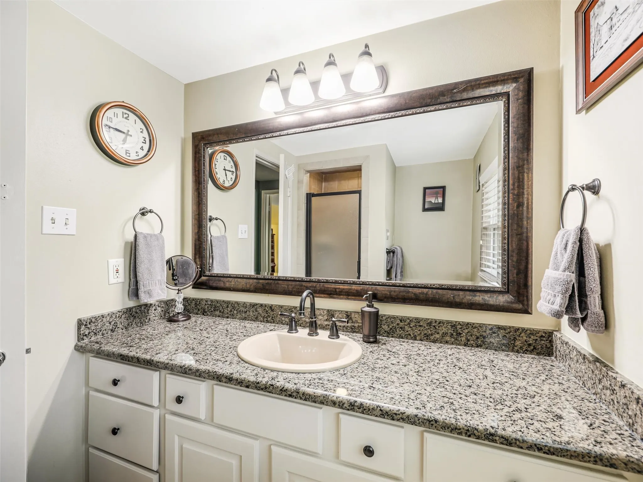 Bathroom with granite countertops in the primary bath and a walk-in shower!