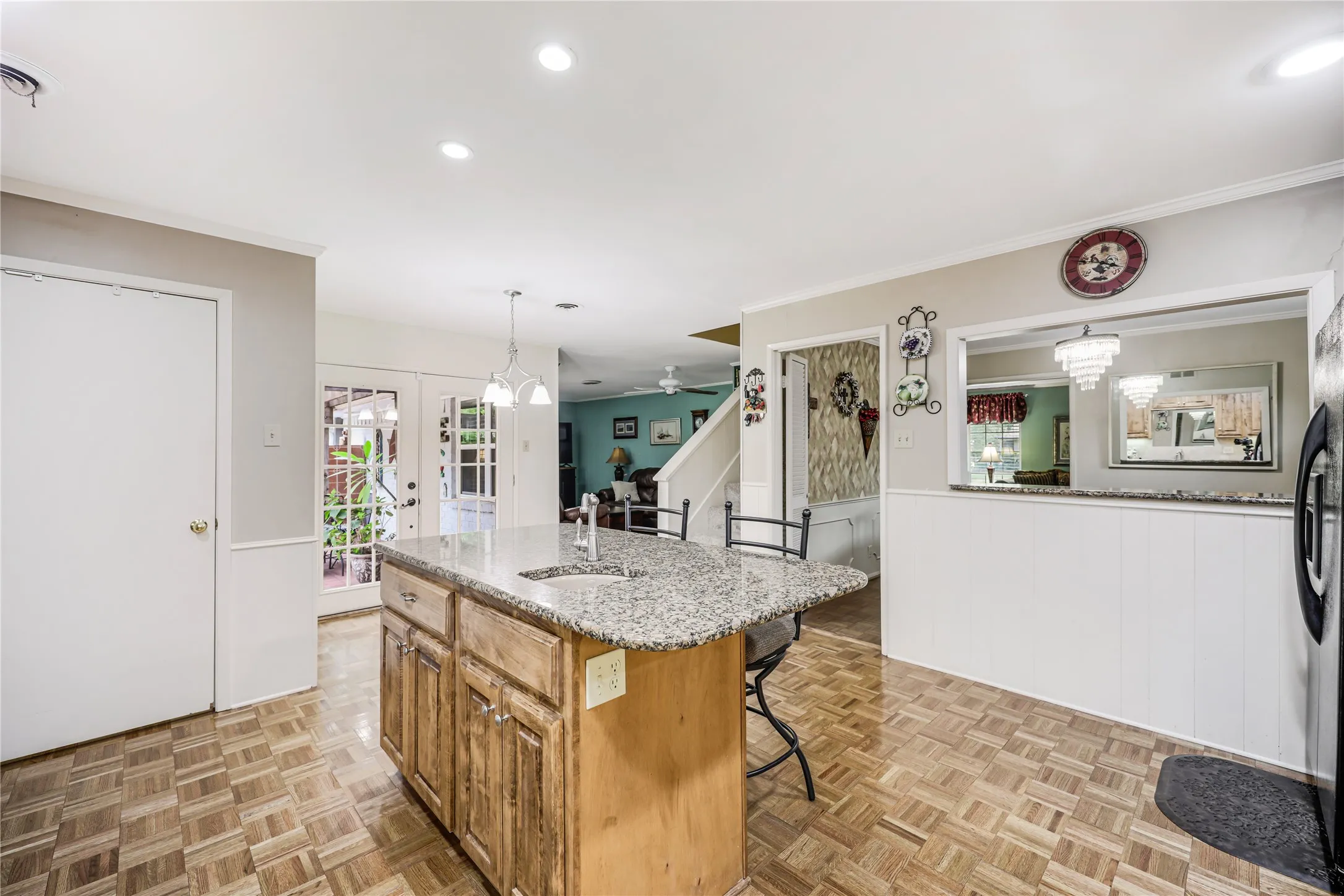 French doors open to exterior covered patio and views that open to the family room and formal dining!