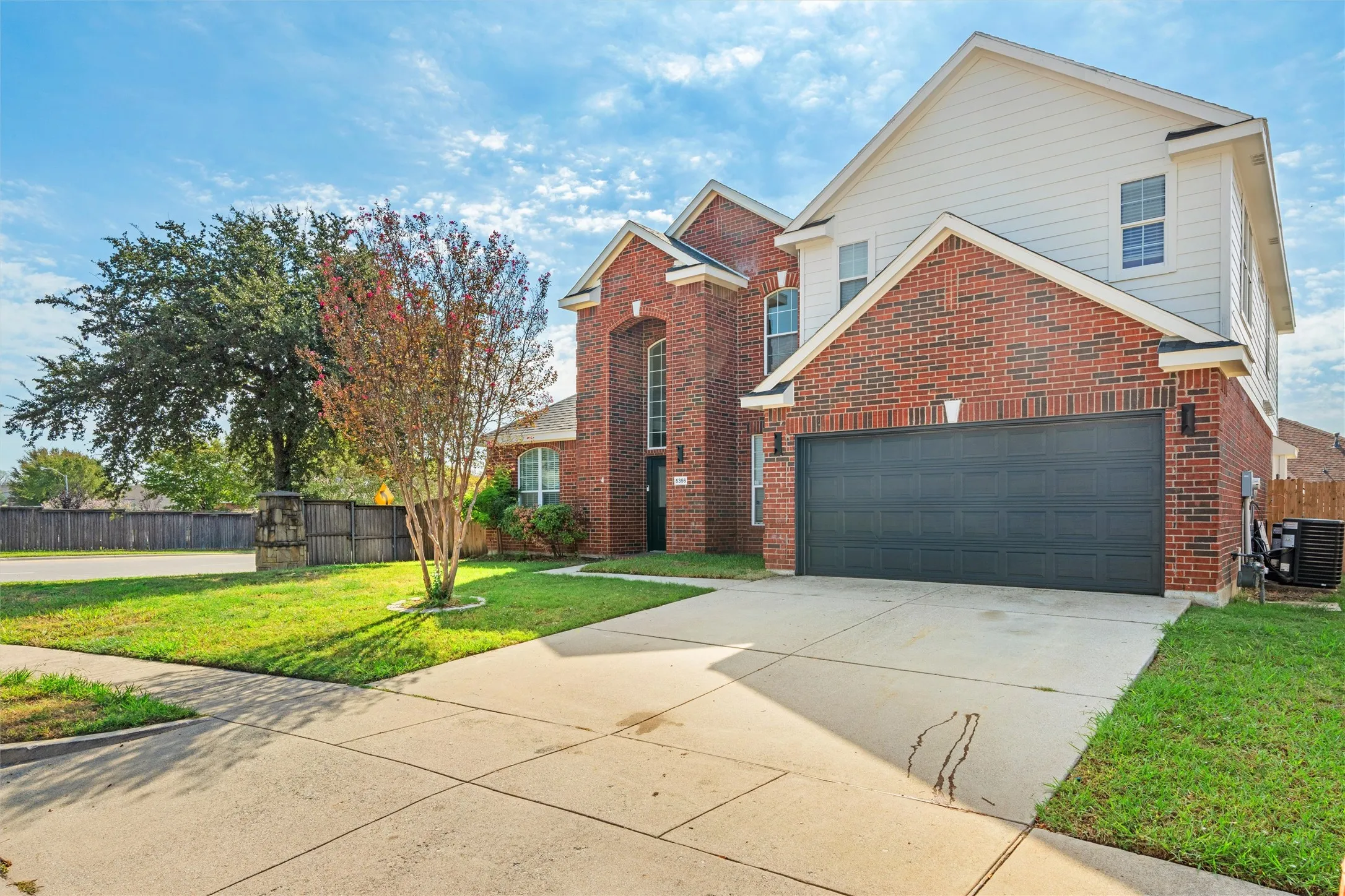 Brick and siding exterior with a two-car garage
