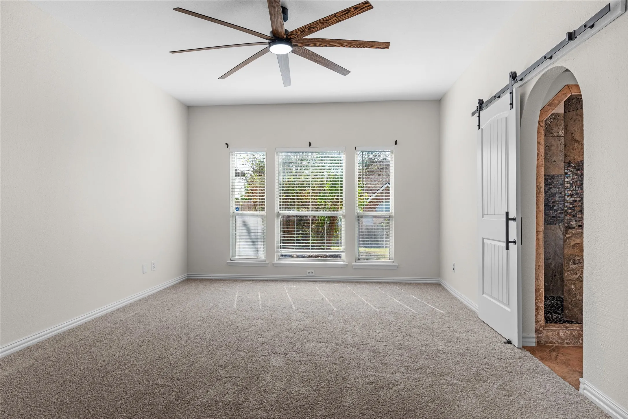 Neutral-toned carpeted flooring complements the light wall color