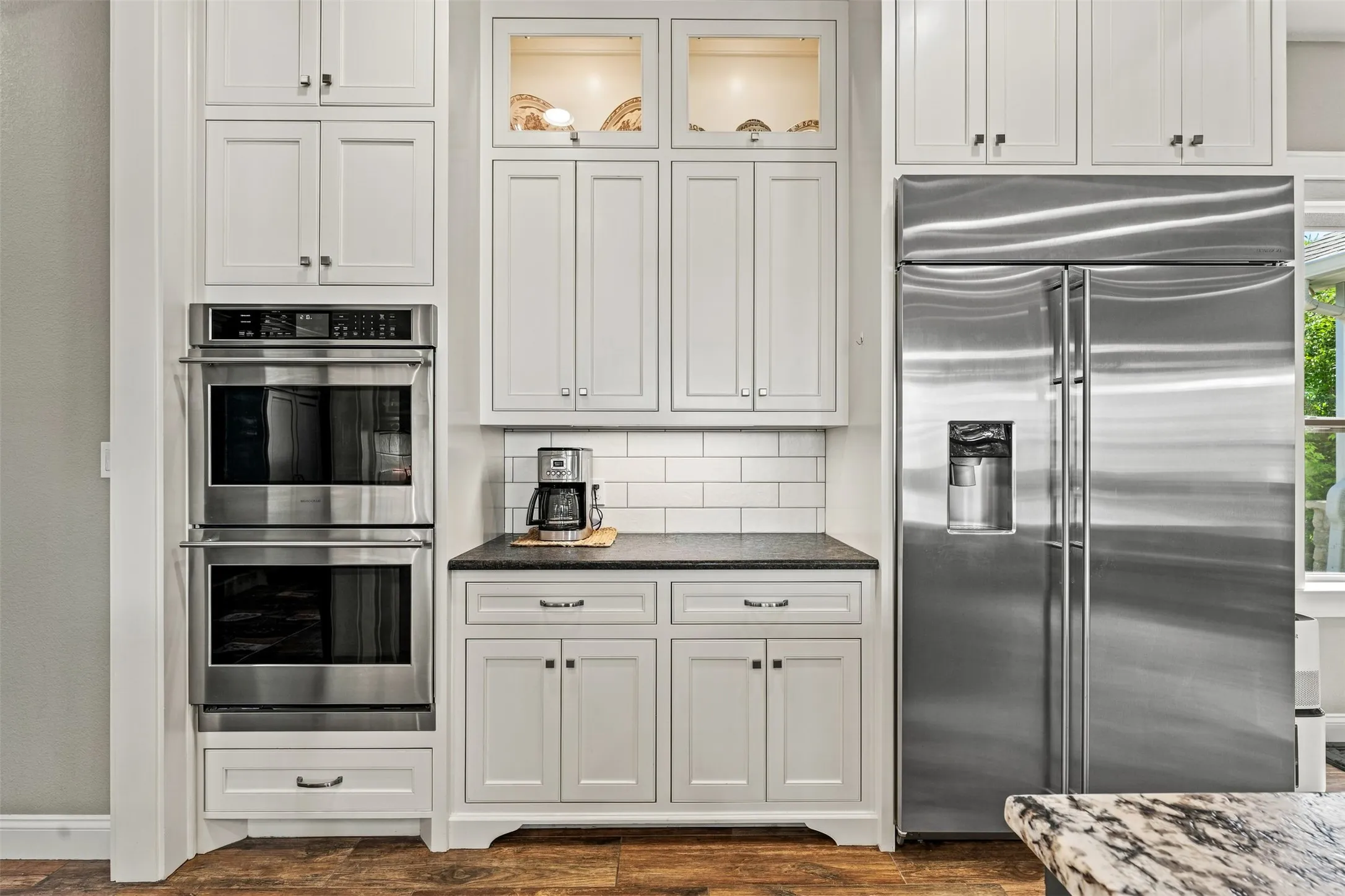 Double ovens, additional cabinetry, and a stainless steel built in refrigerator.