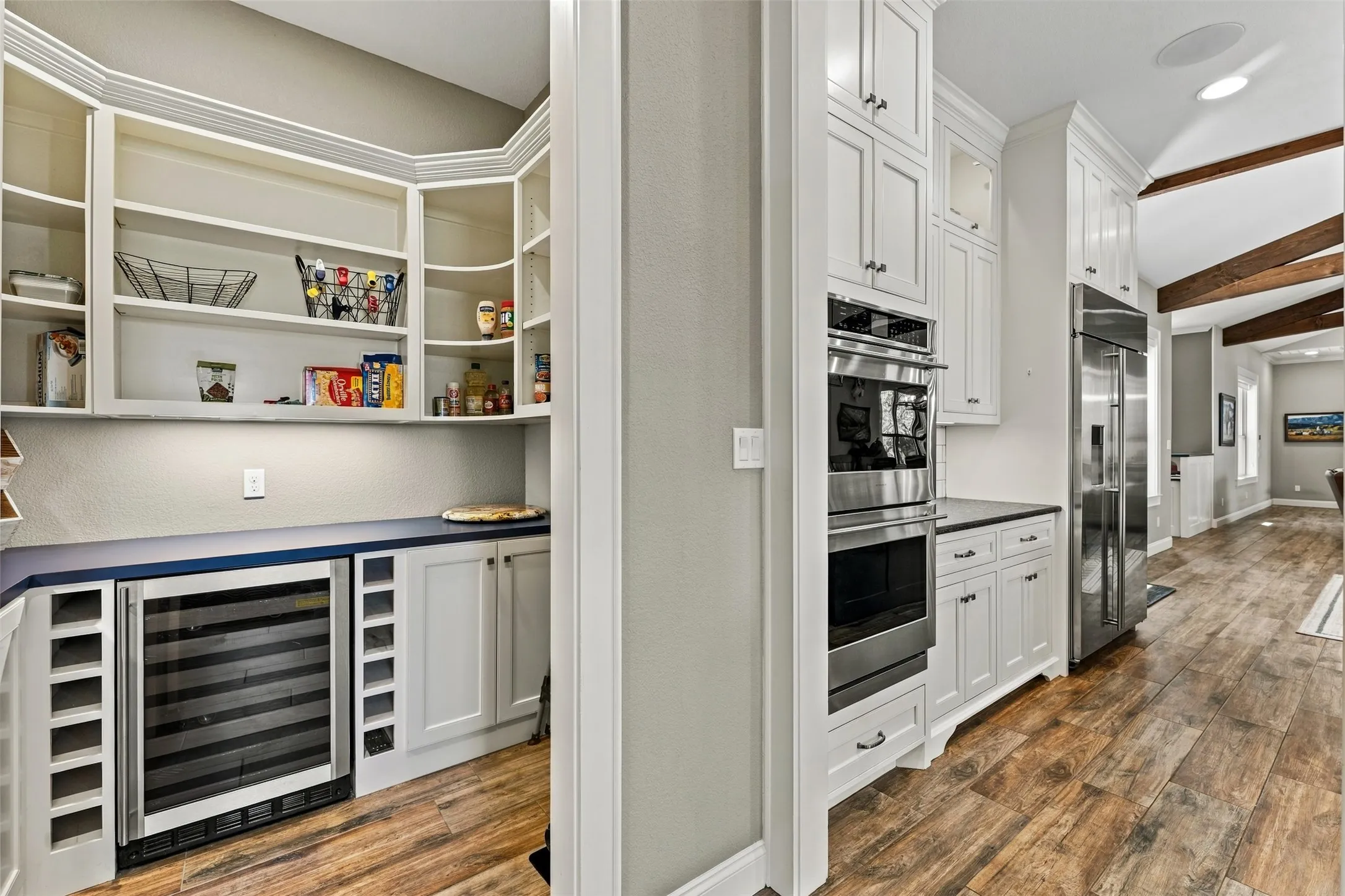 The pantry is located right off of the kitchen and is equipped with a wine refrigerator and plenty of room for appliances as well.
