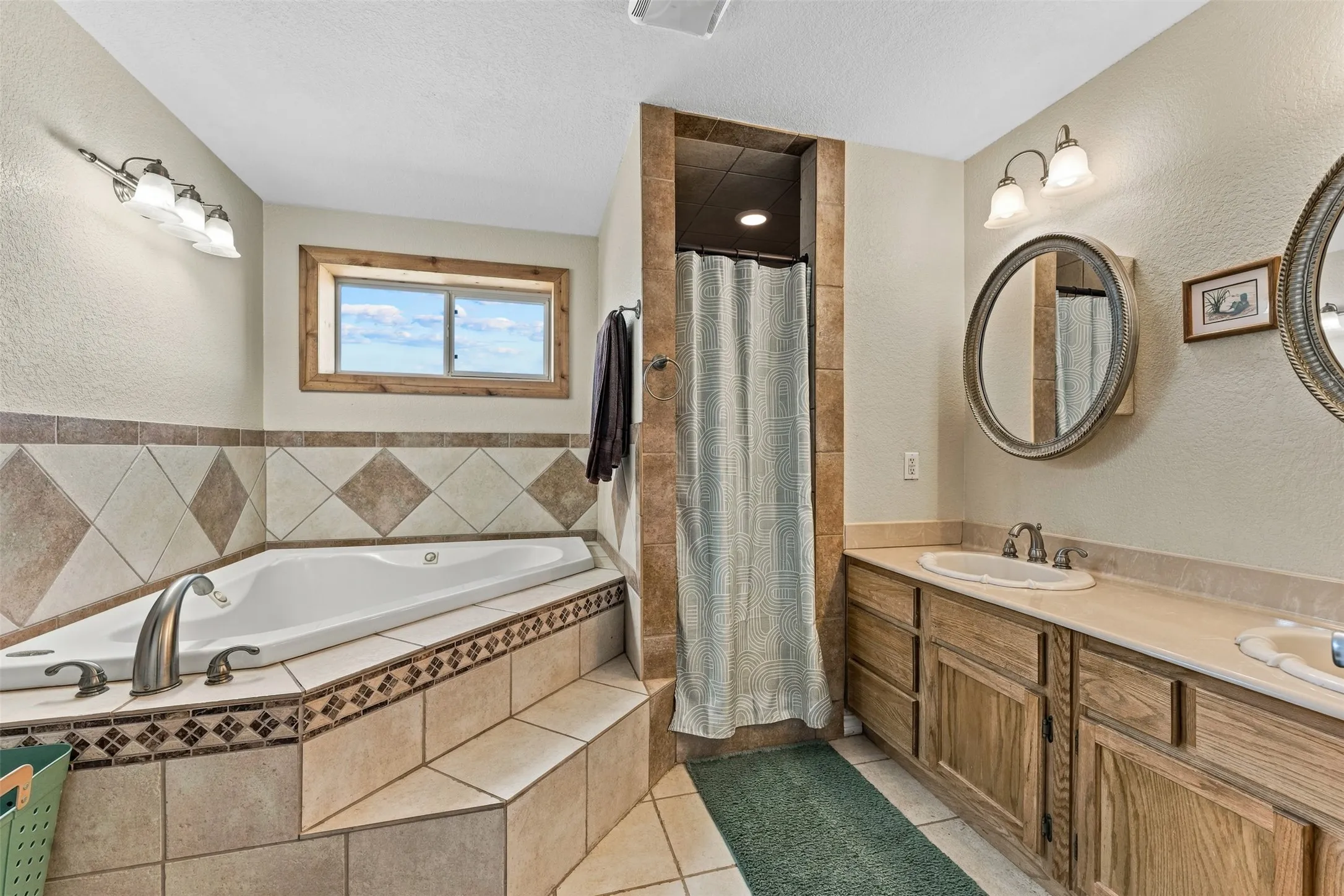 The guest house bathroom features a jacuzzi bathtub and dual sinks.