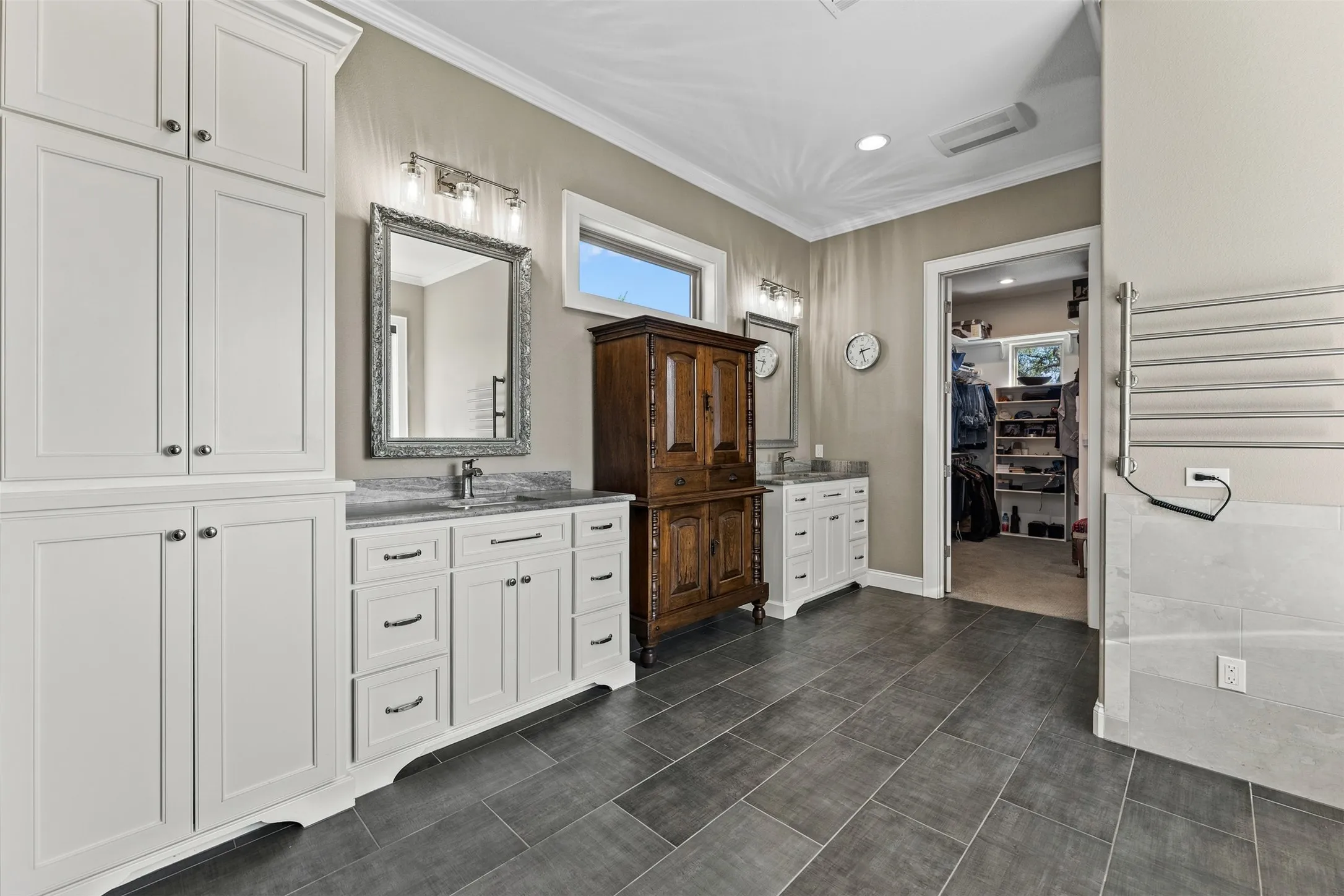 The primary bath has a double vanity and lots of storage.