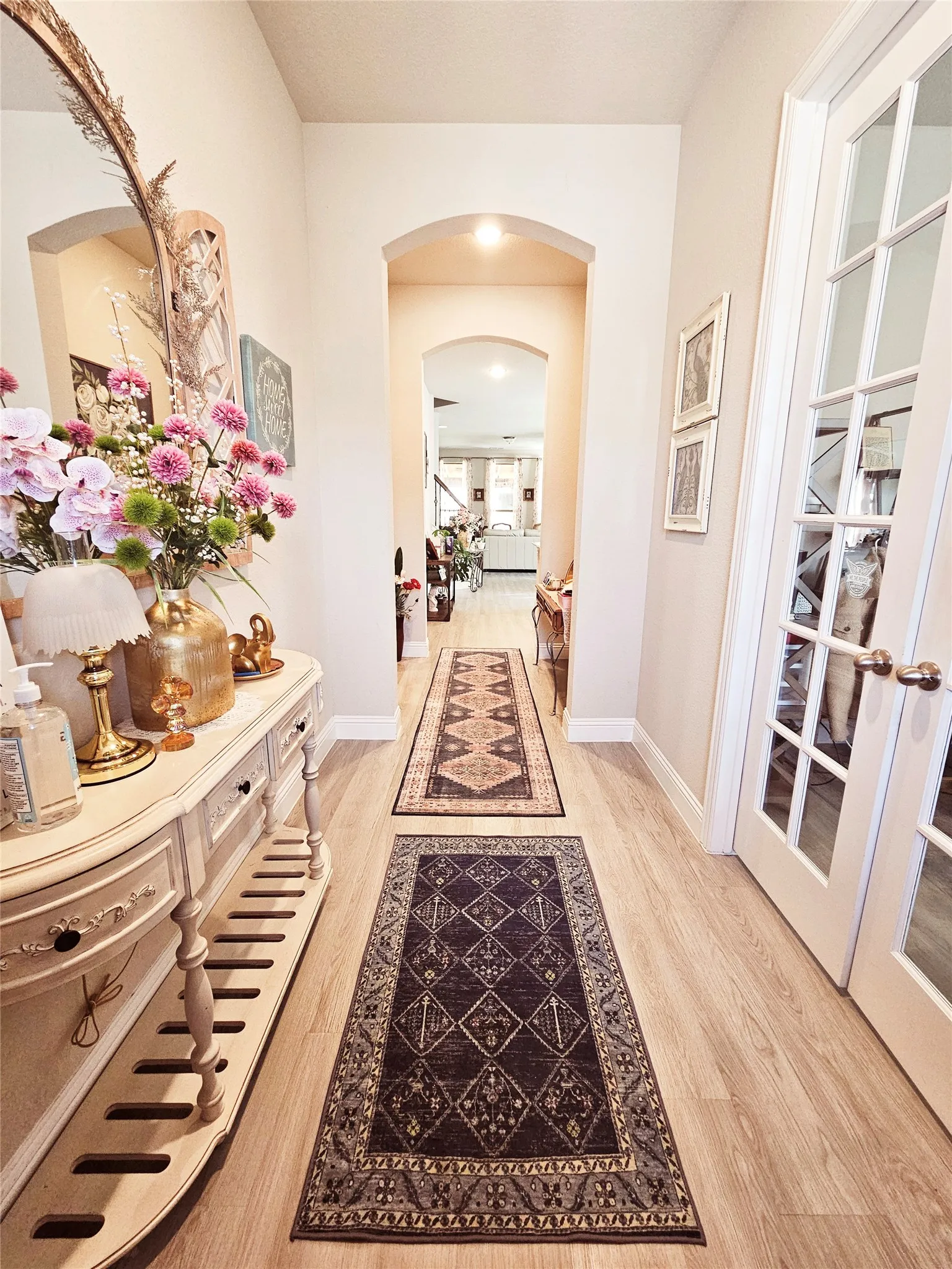 Wood-finish flooring throughout the hallway