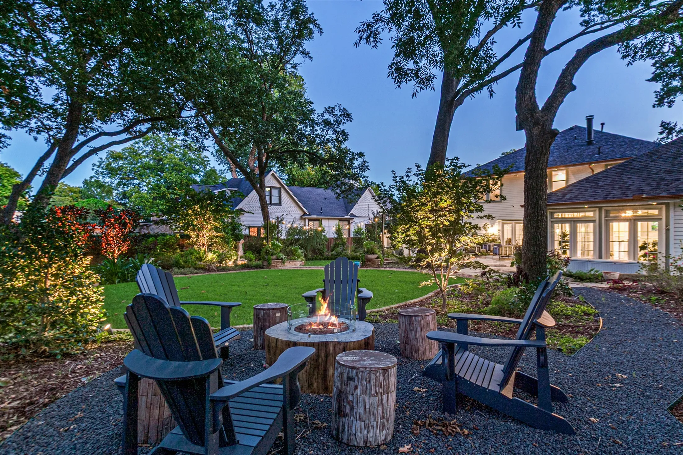 View of garden with fire pit, dog run, patio and outdoor dining area