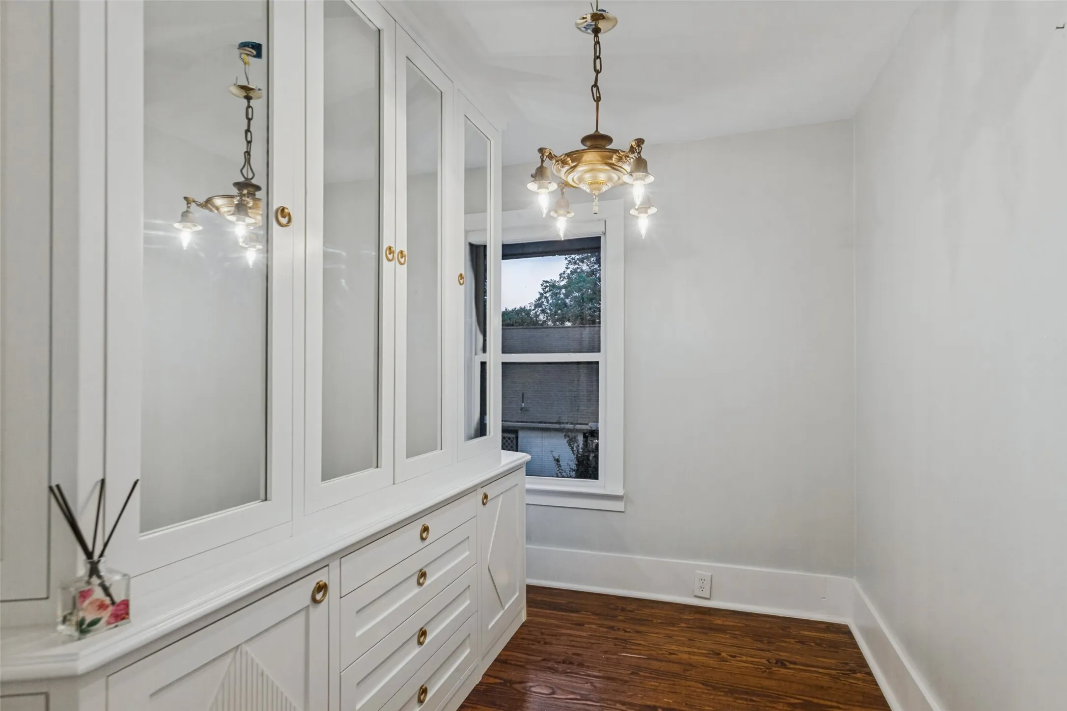Dressing room with built-in storage, could double as second walk in closet off primary bedroom with bars installed