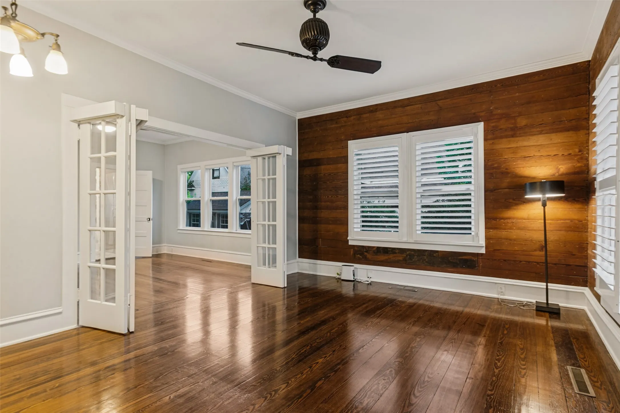 Located in the front room, this office features shiplap from when the house was originally built is 1890, french doors open to bedroom with option to close shades on french doors with automatic shades