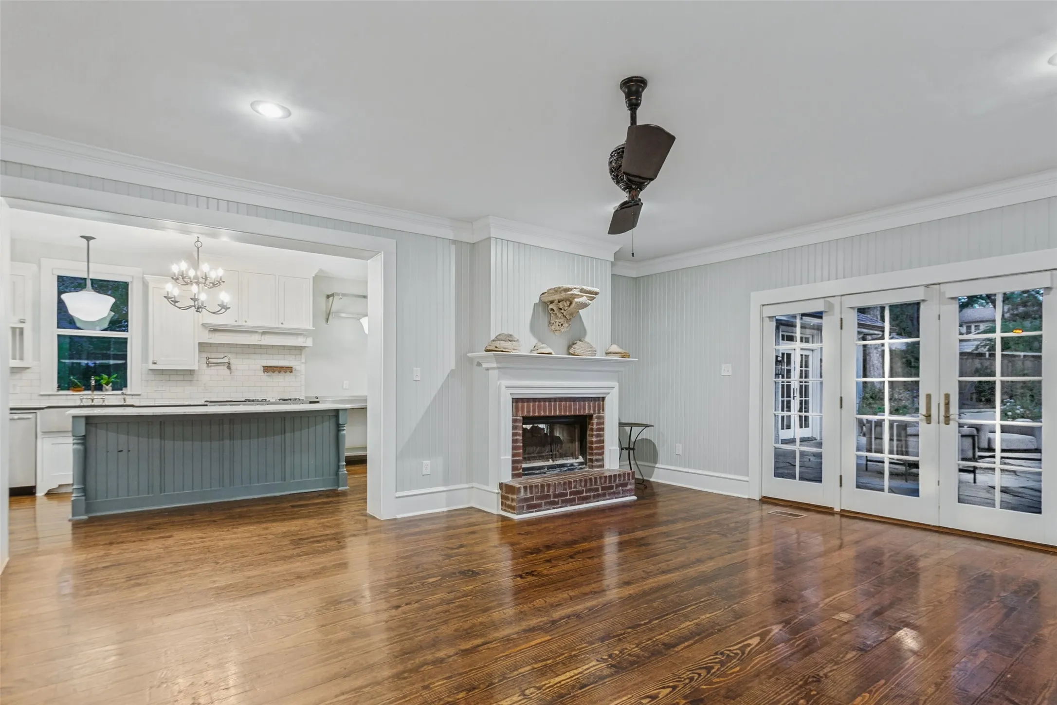 Living Room with view of the kitchen, fireplace, and views into the beautiful backyard